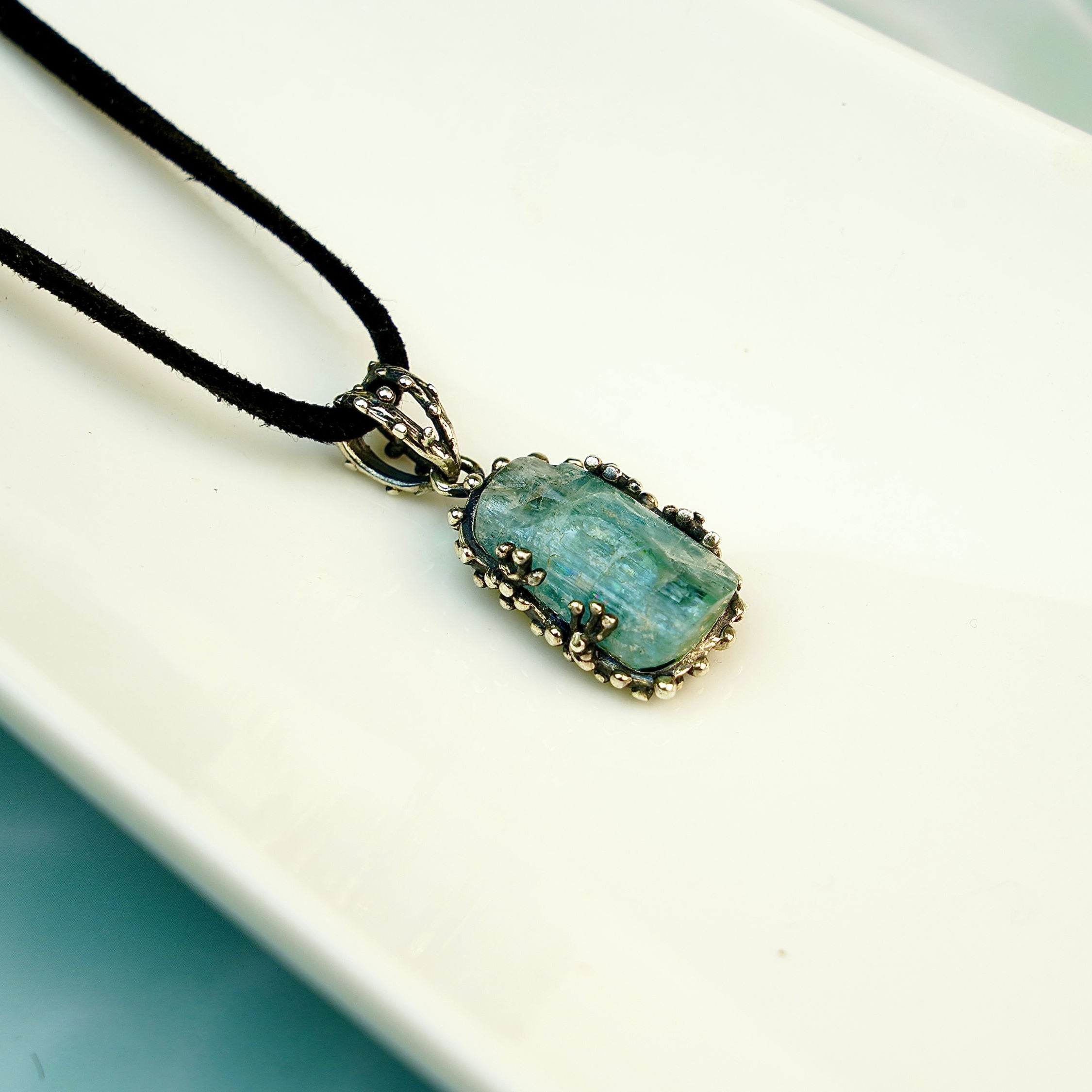 Side profile aquamarine pendant thickness sterling silver setting detail