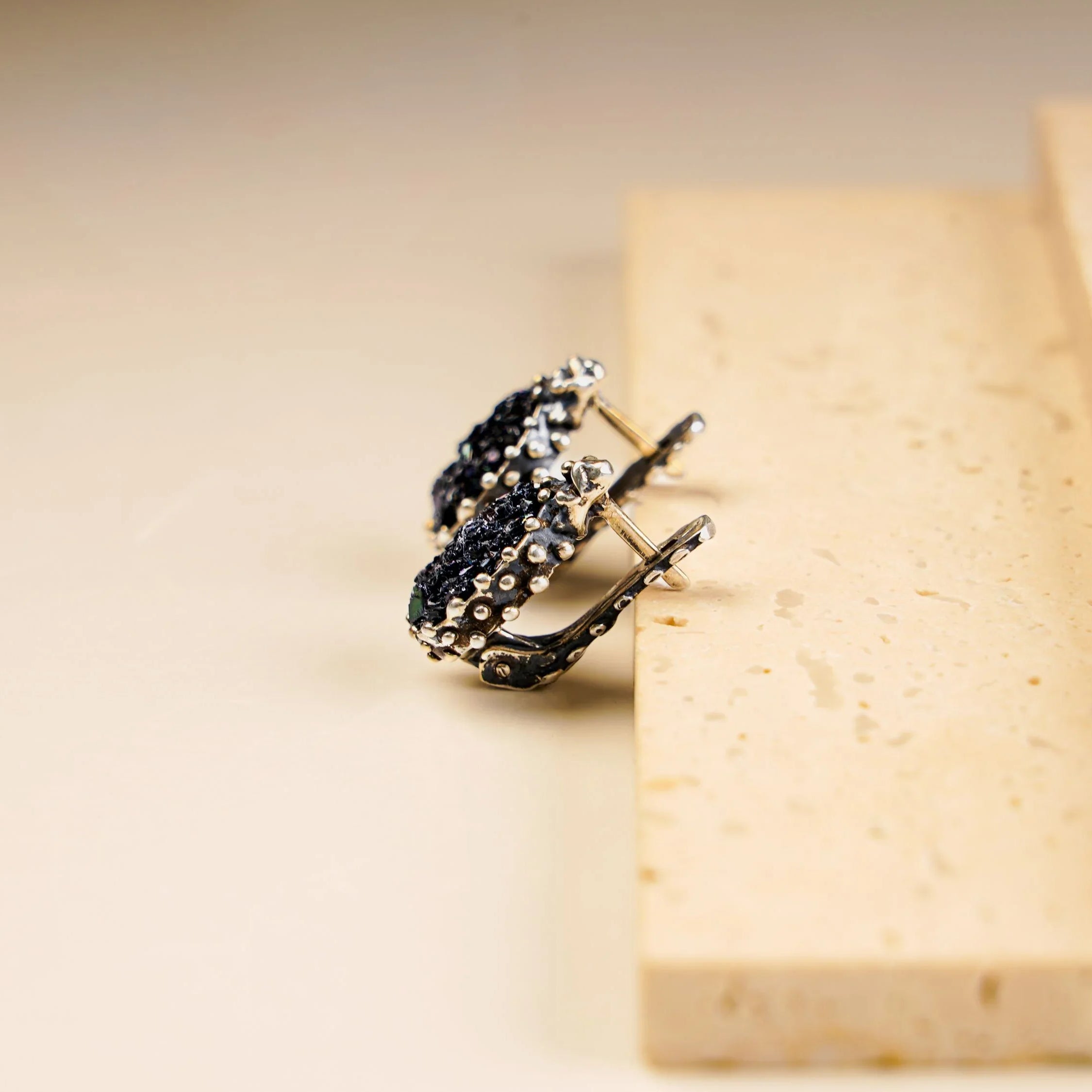 Black moissanite earrings side view sterling silver leverback design