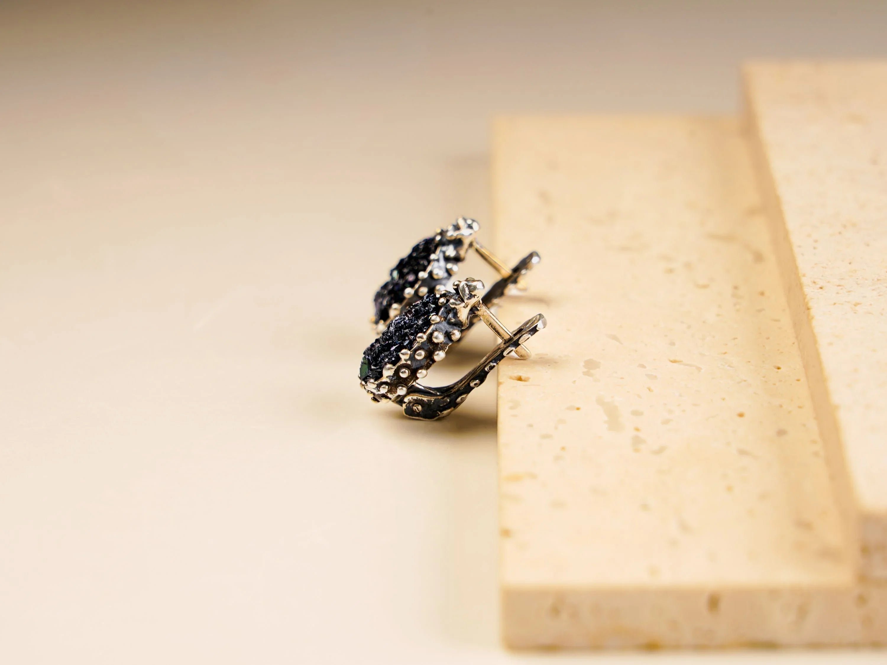 Black moissanite earrings side view sterling silver leverback design