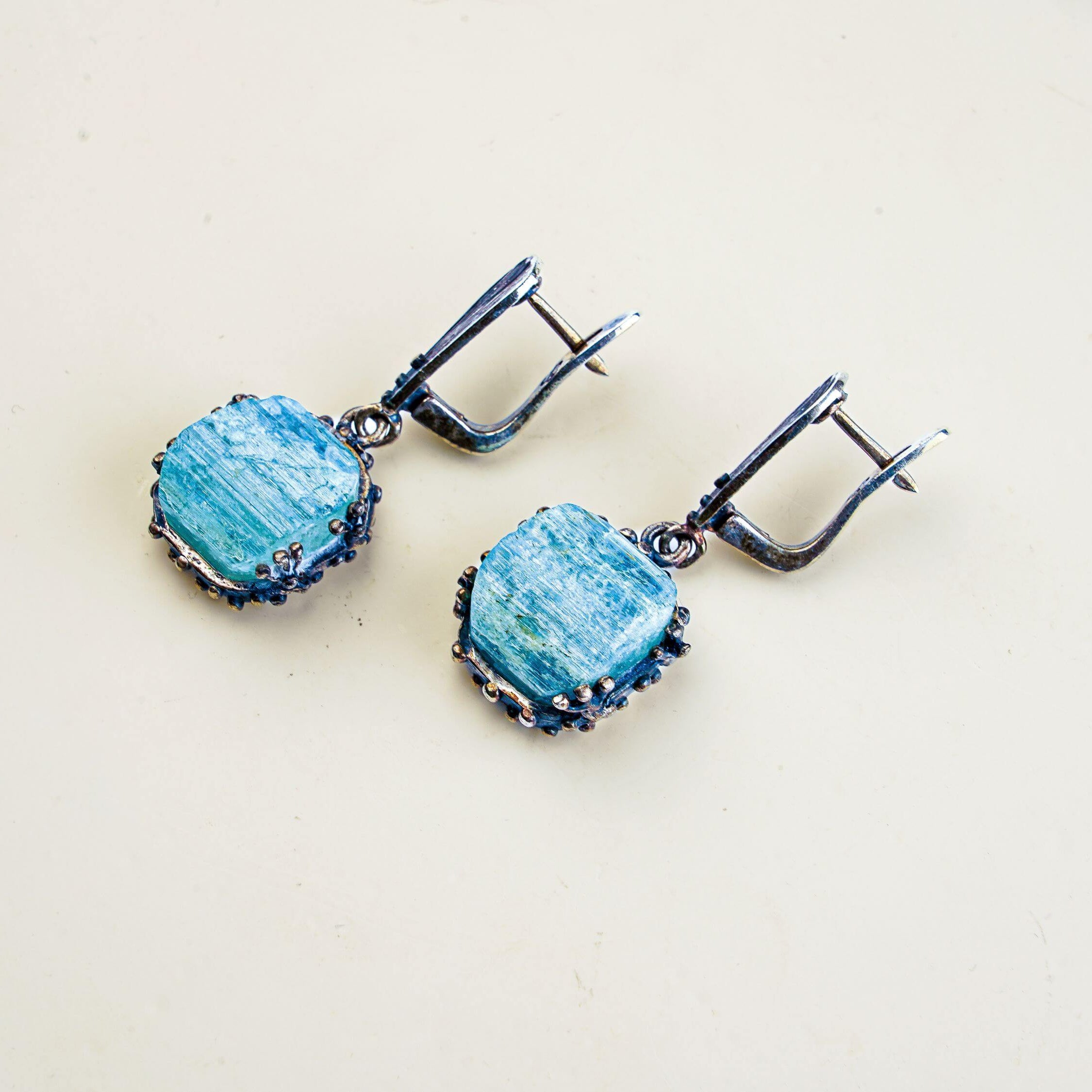 Angle view aquamarine earrings raw aqua crystal silver drop earrings perspective