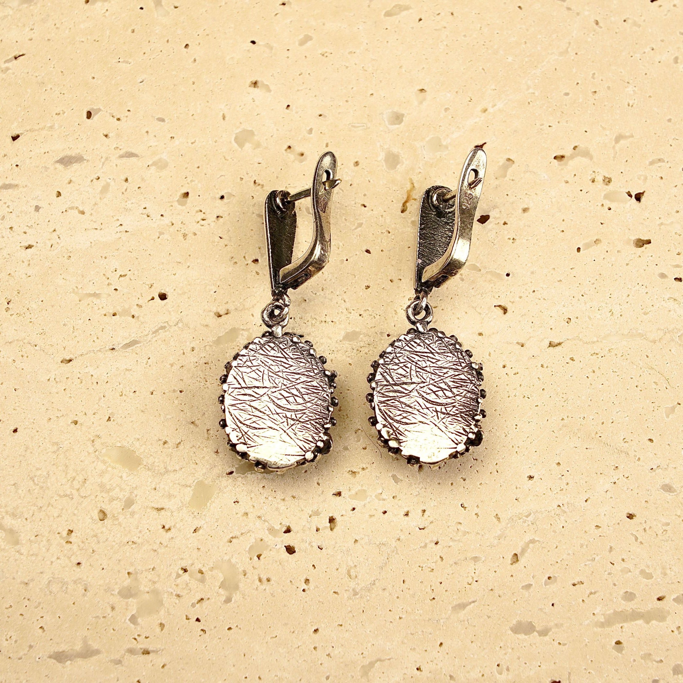 backside of rose quartz earrings, secure leverback sterling silver detail