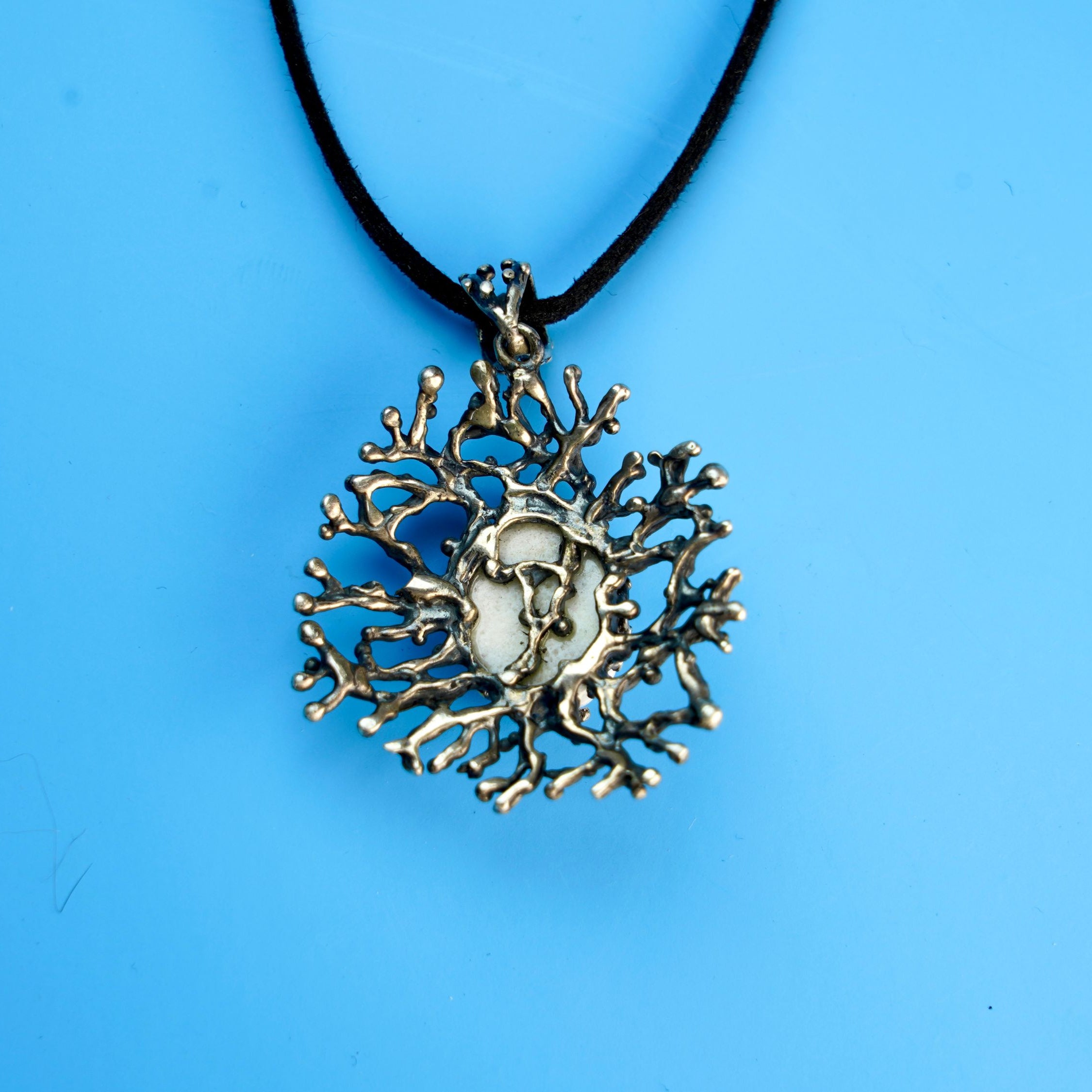 backside of moonstone pendant, handcrafted sterling silver detail