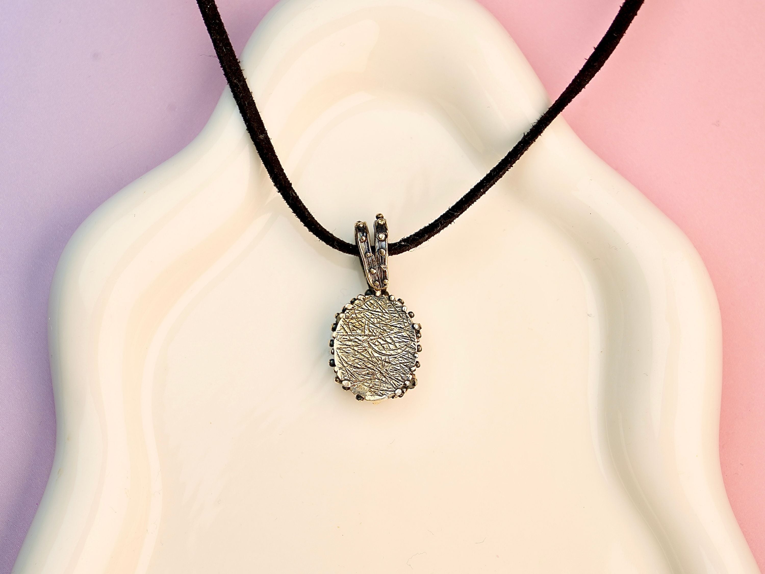 Rose quartz necklace backside silver setting detail natural gemstone pendant