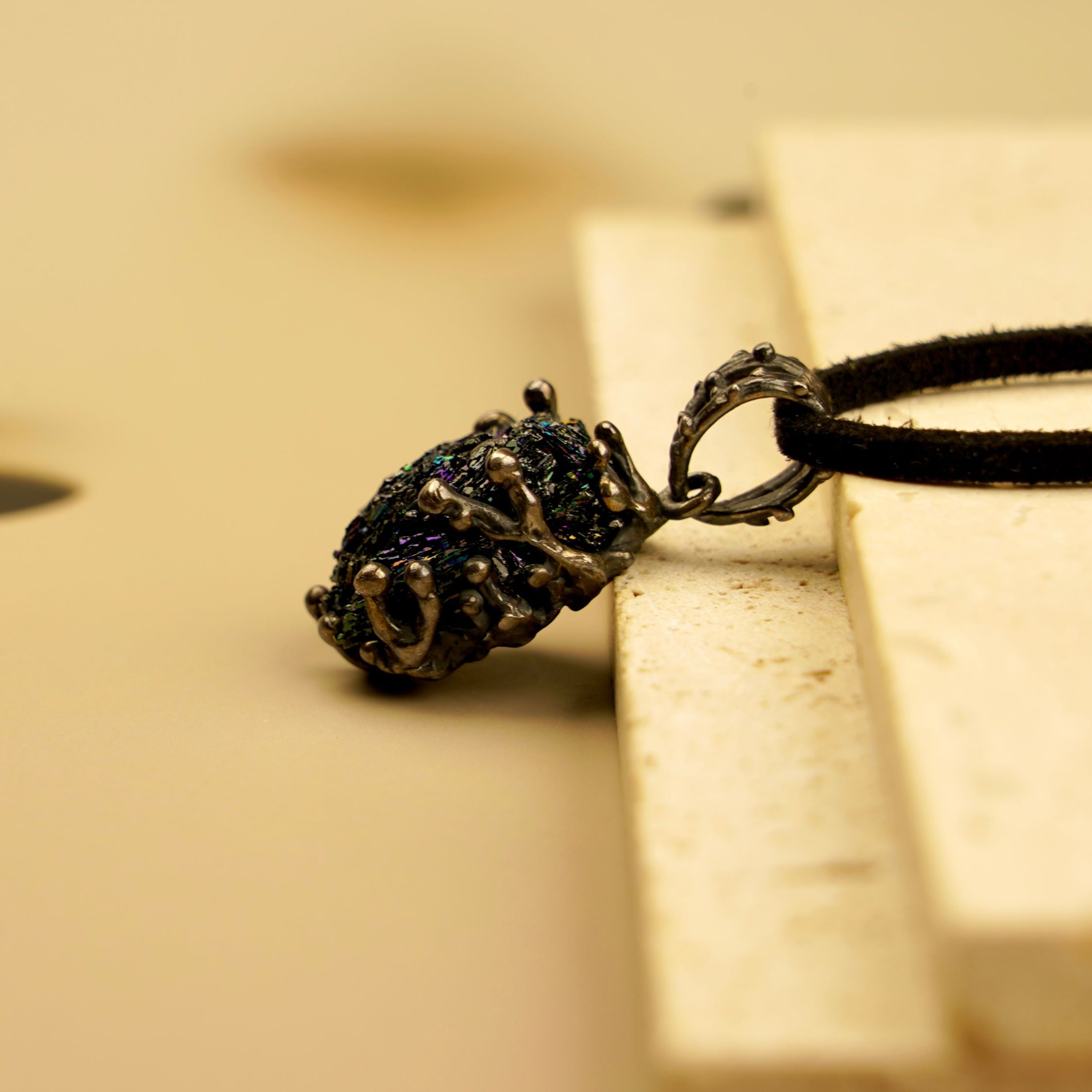 Minimalist artistic shot of the AKRA Obsidian necklace, highlighting its raw aesthetic and natural beauty