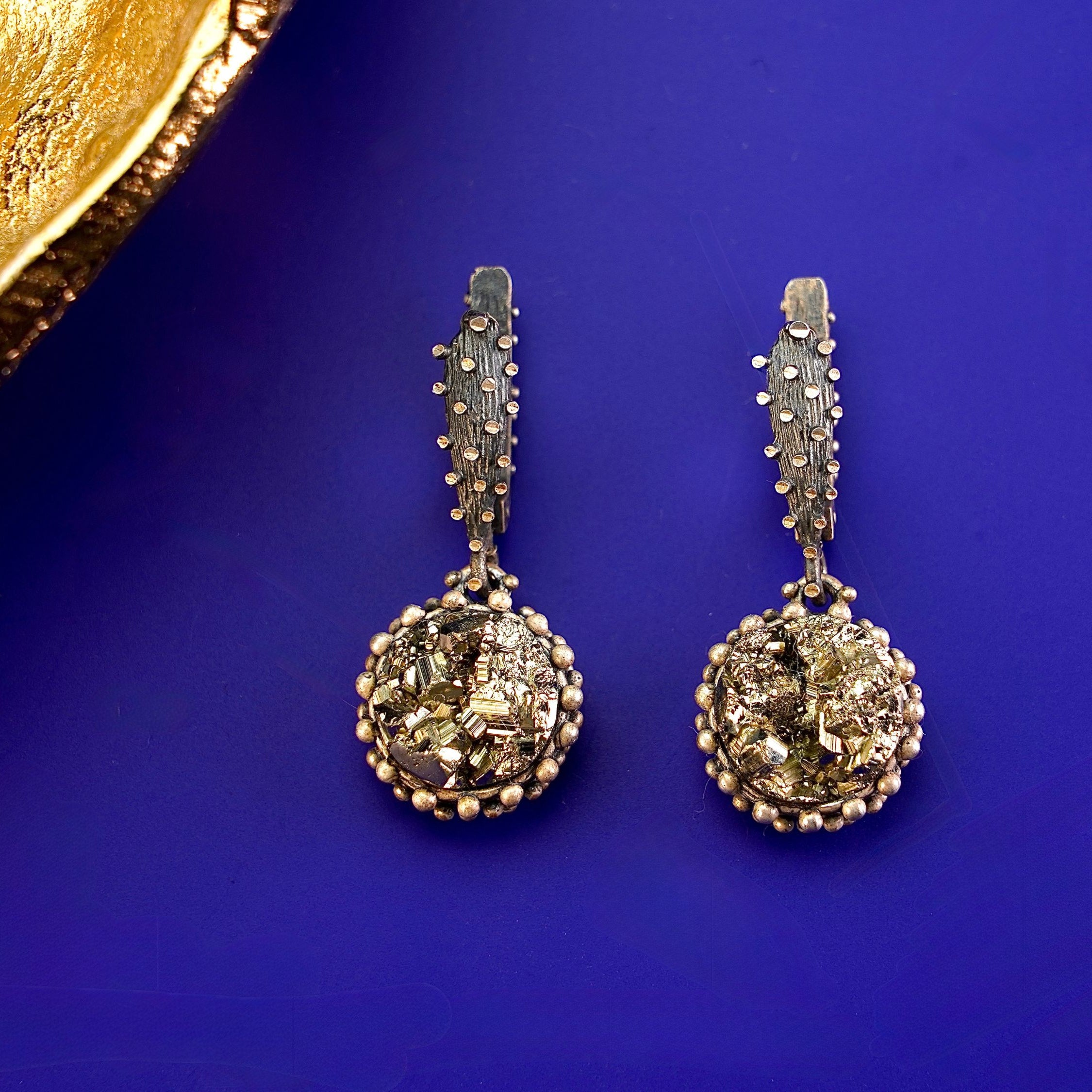 Detailed variation pyrite earrings gold crystal cluster texture macro shot
