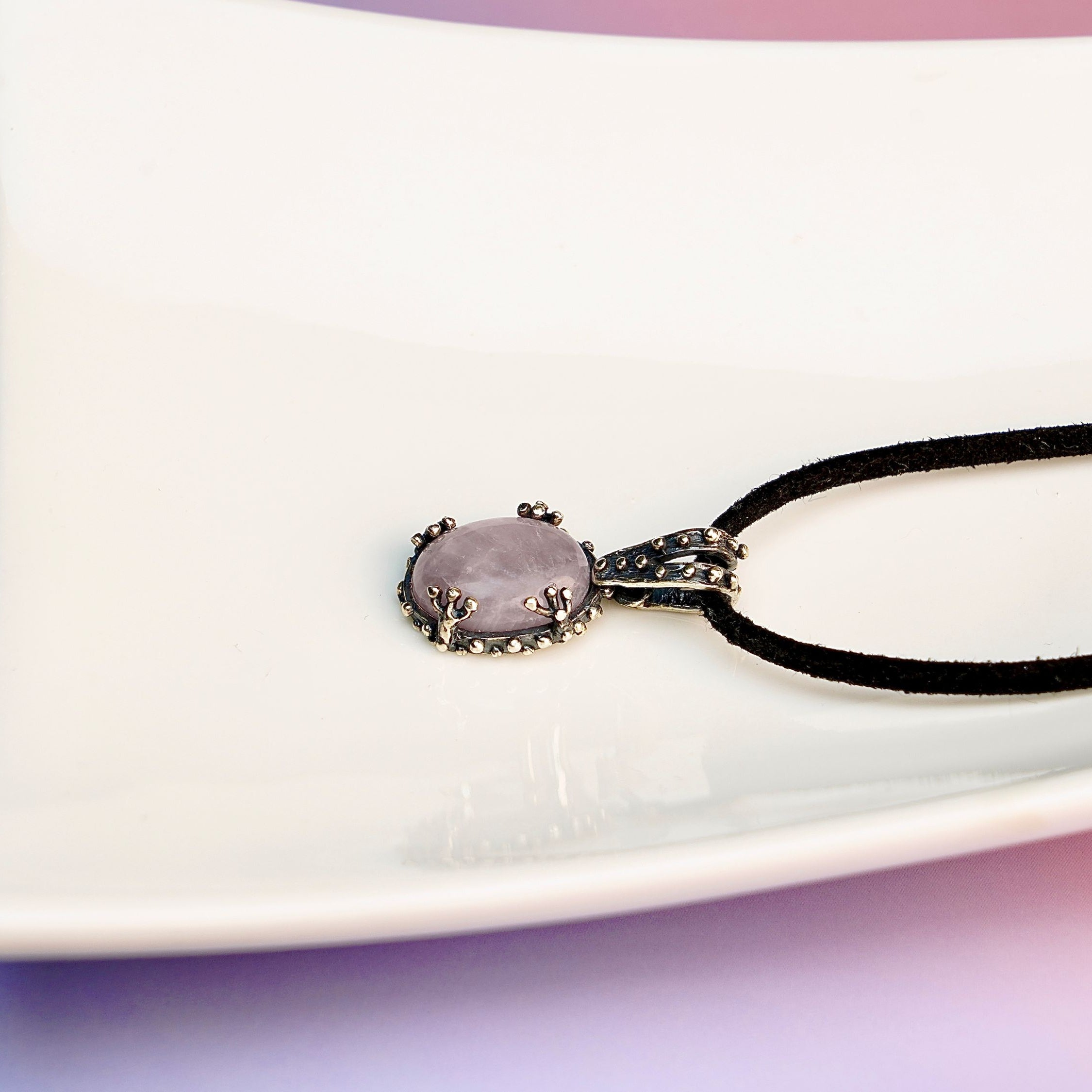 Rose quartz necklace detailed texture soft pink gemstone close up natural pattern