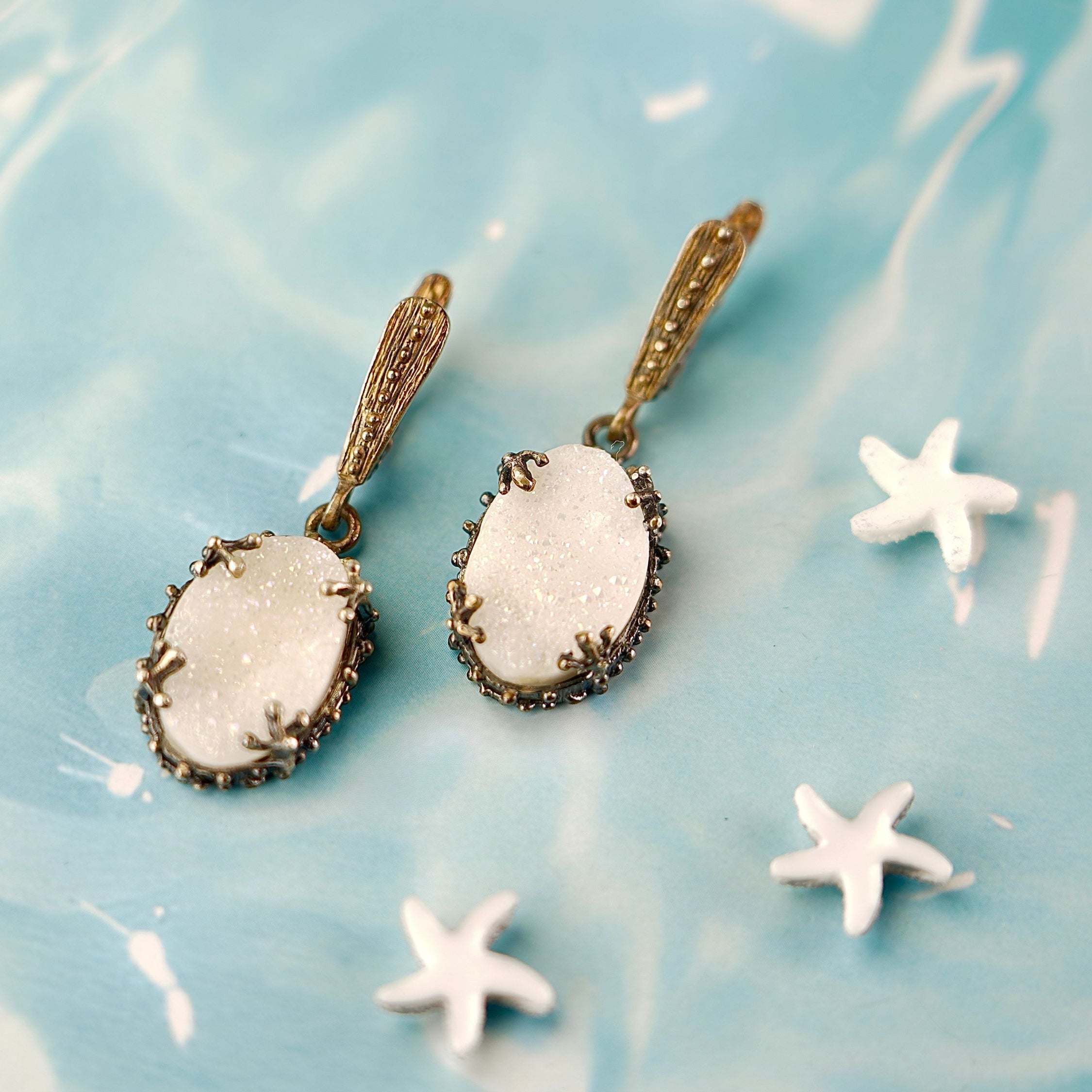 Alternative close up moonstone earrings glowing white stone macro detail variation