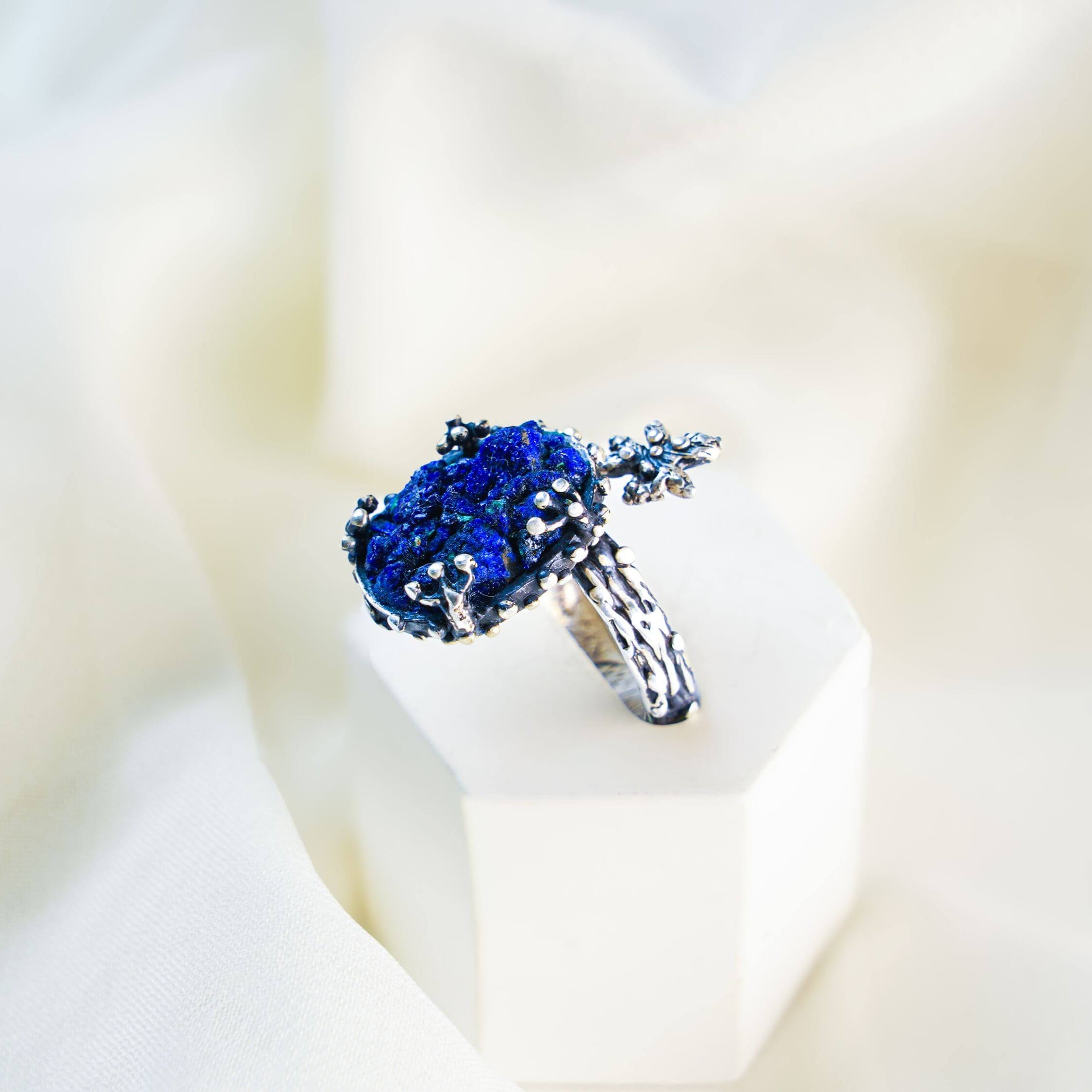Vertical aesthetic shot of the handcrafted silver branch ring with a round lapis lazuli stone