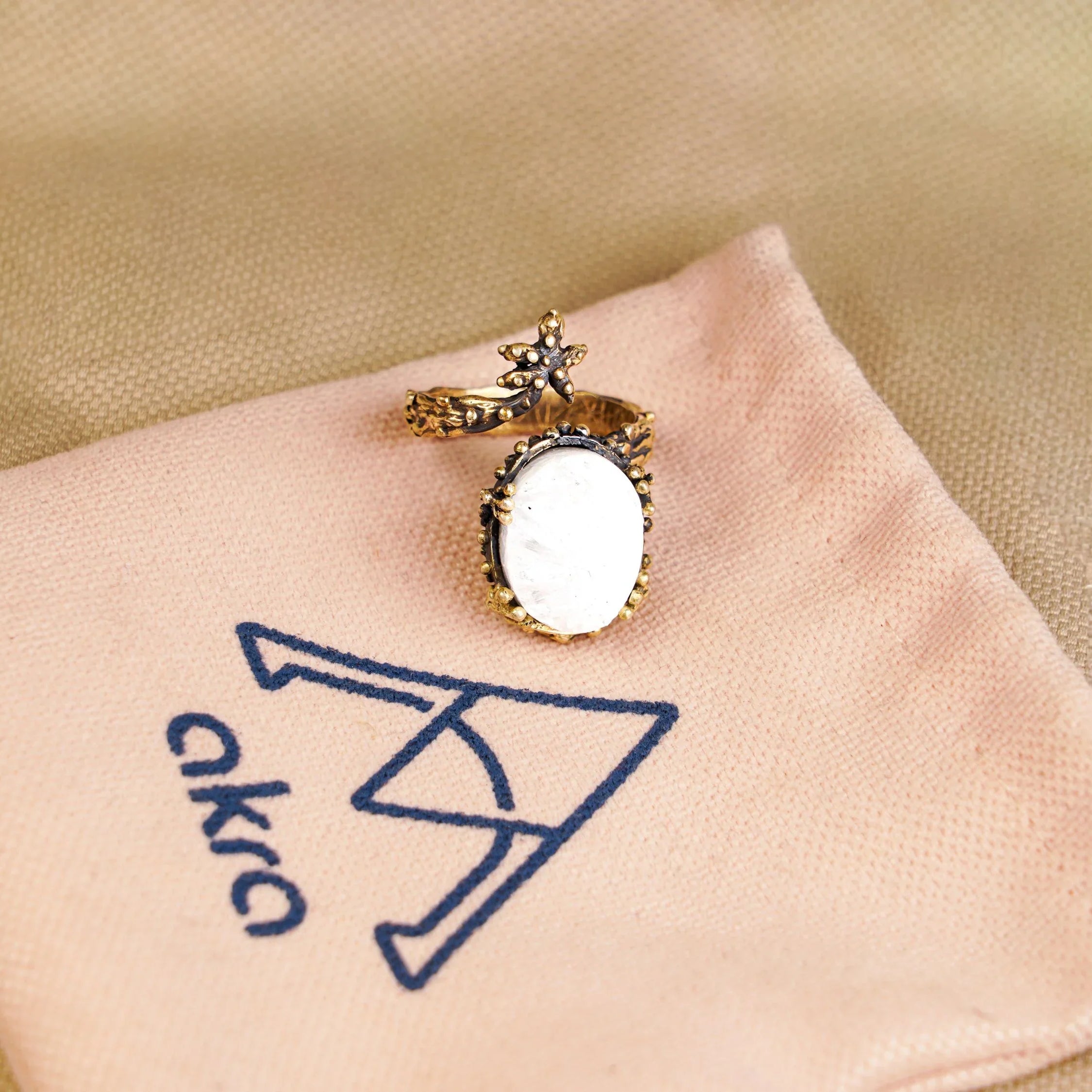 Moonstone ring on pouch branding jewelry presentation aesthetic