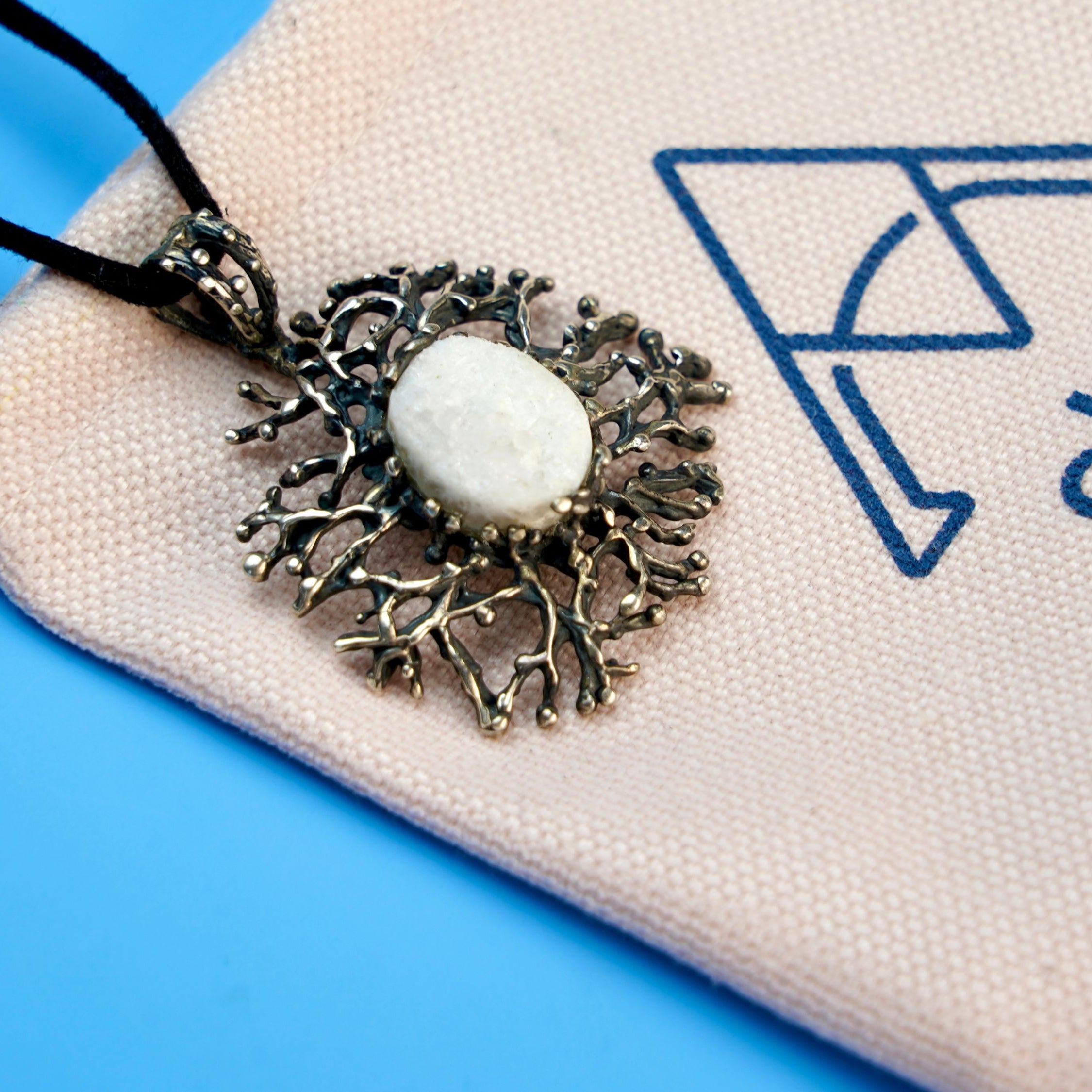 moonstone necklace lifestyle shot, artistic statement jewelry aesthetic