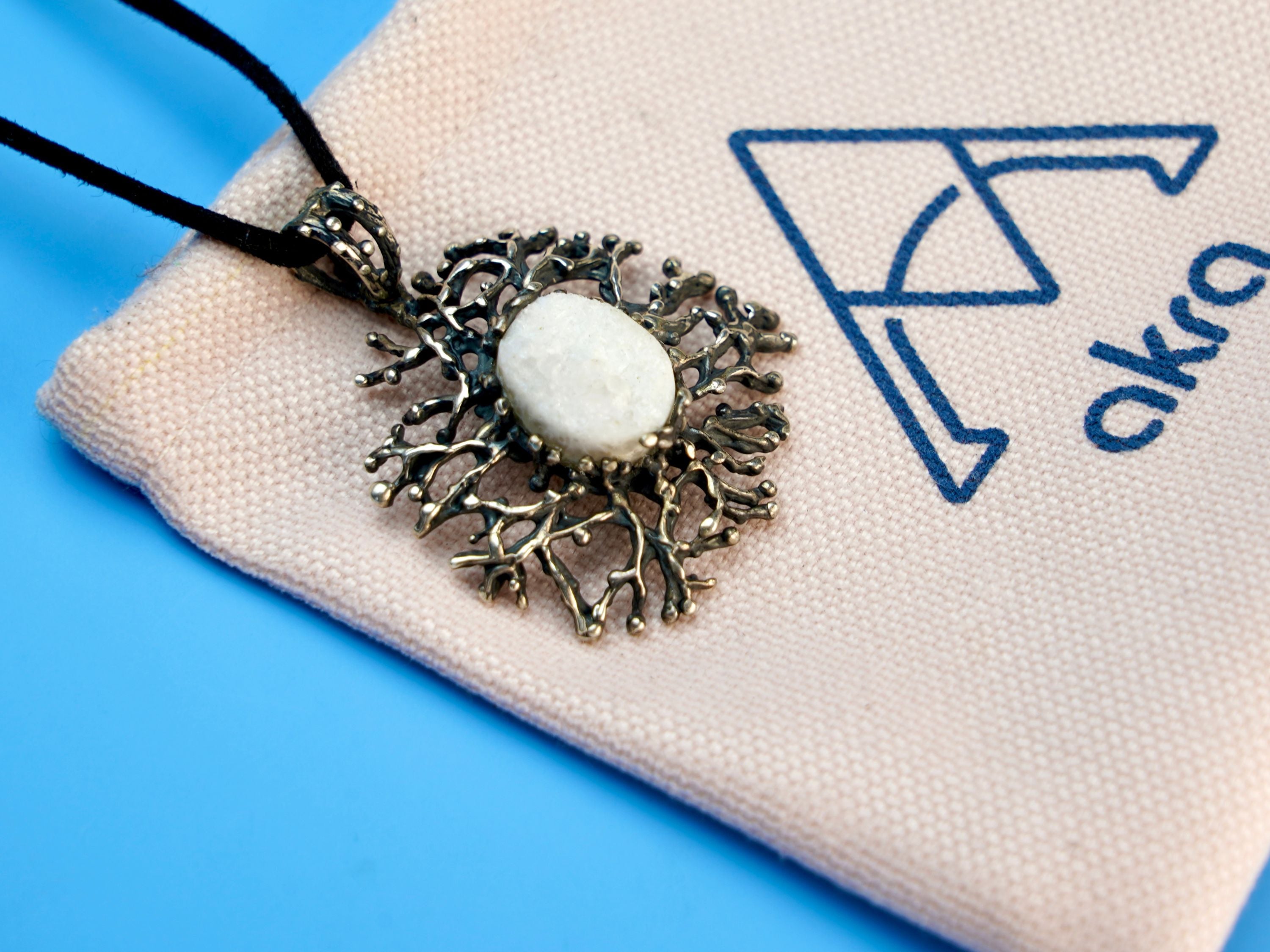 moonstone necklace lifestyle shot, artistic statement jewelry aesthetic