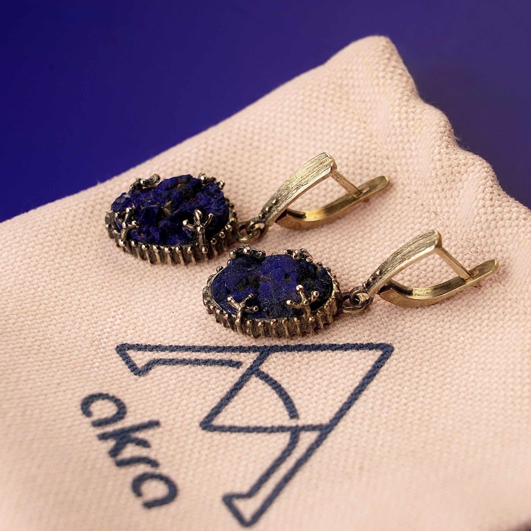 Lifestyle lapis lazuli earrings bold blue gemstone jewelry styled composition