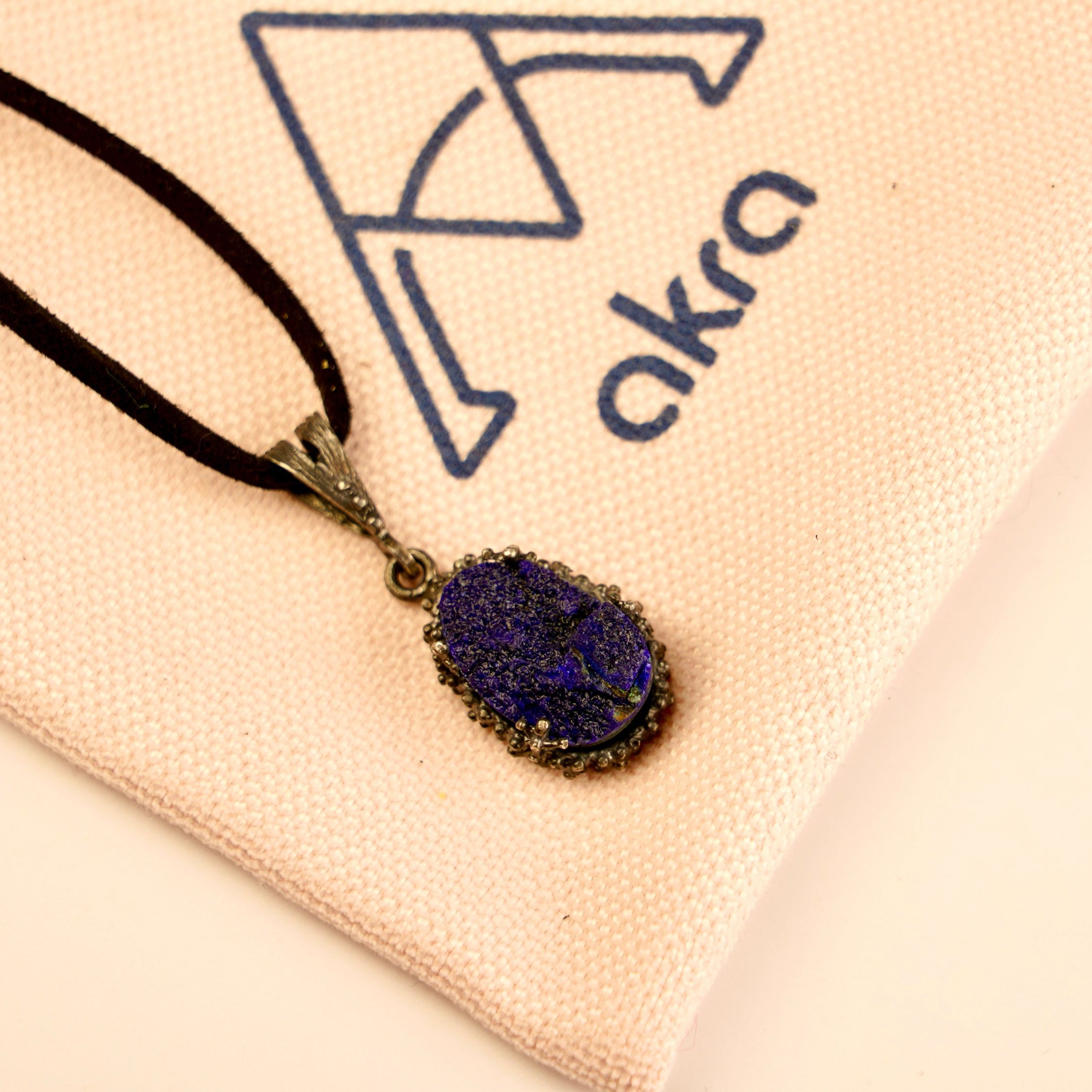 lapis lazuli pendant necklace lifestyle shot, minimal blue gemstone jewelry style