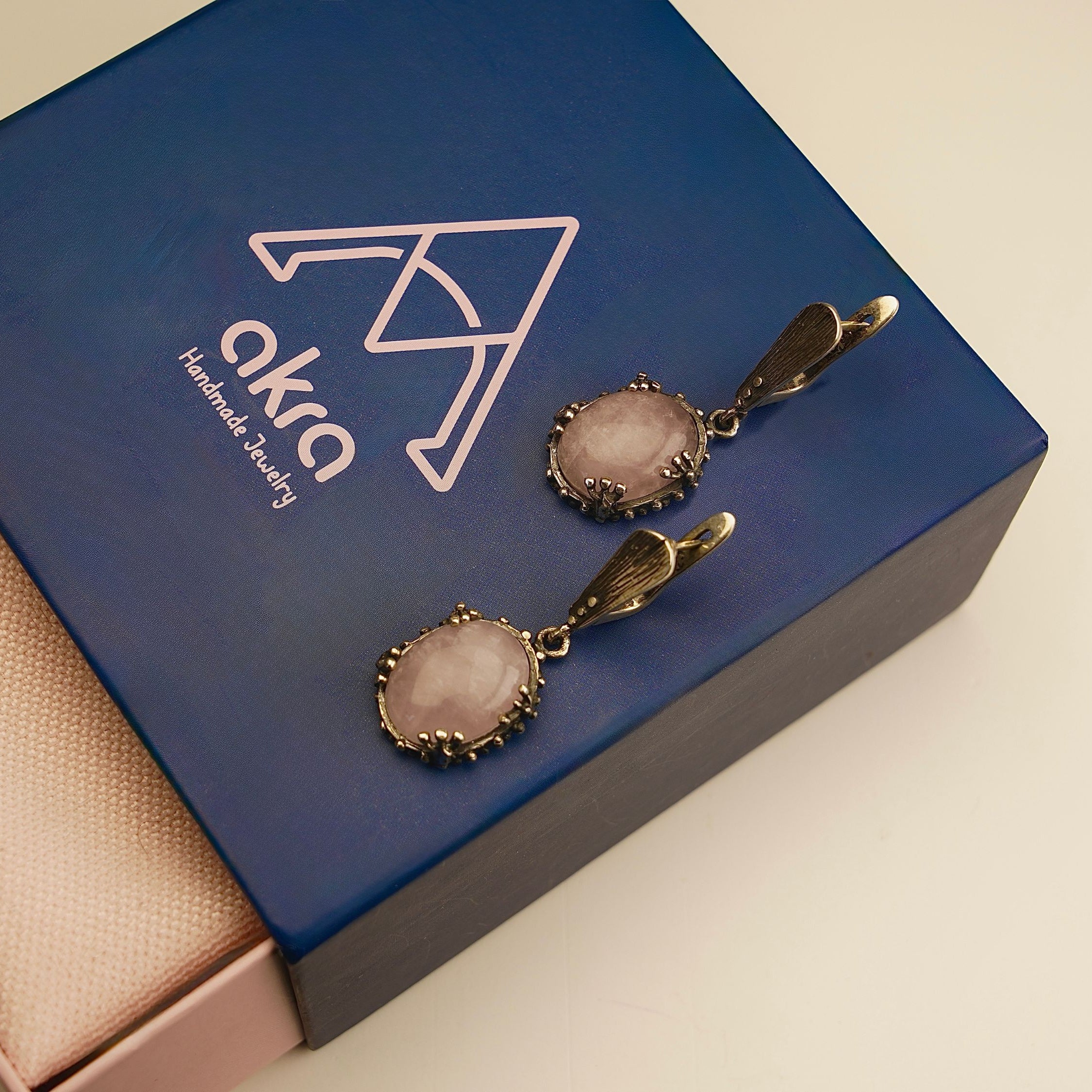 rose quartz earrings lifestyle shot, romantic feminine jewelry aesthetic
