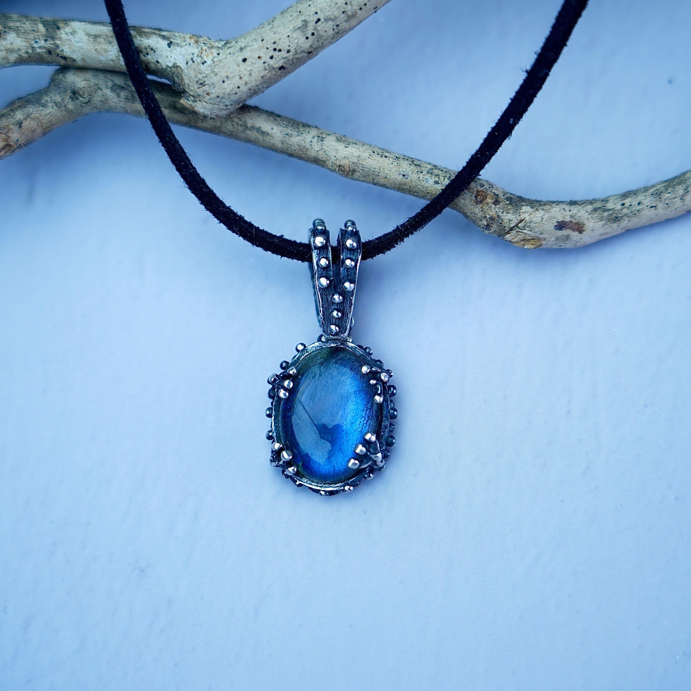 Lifestyle labradorite necklace blue flash jewelry natural styled composition