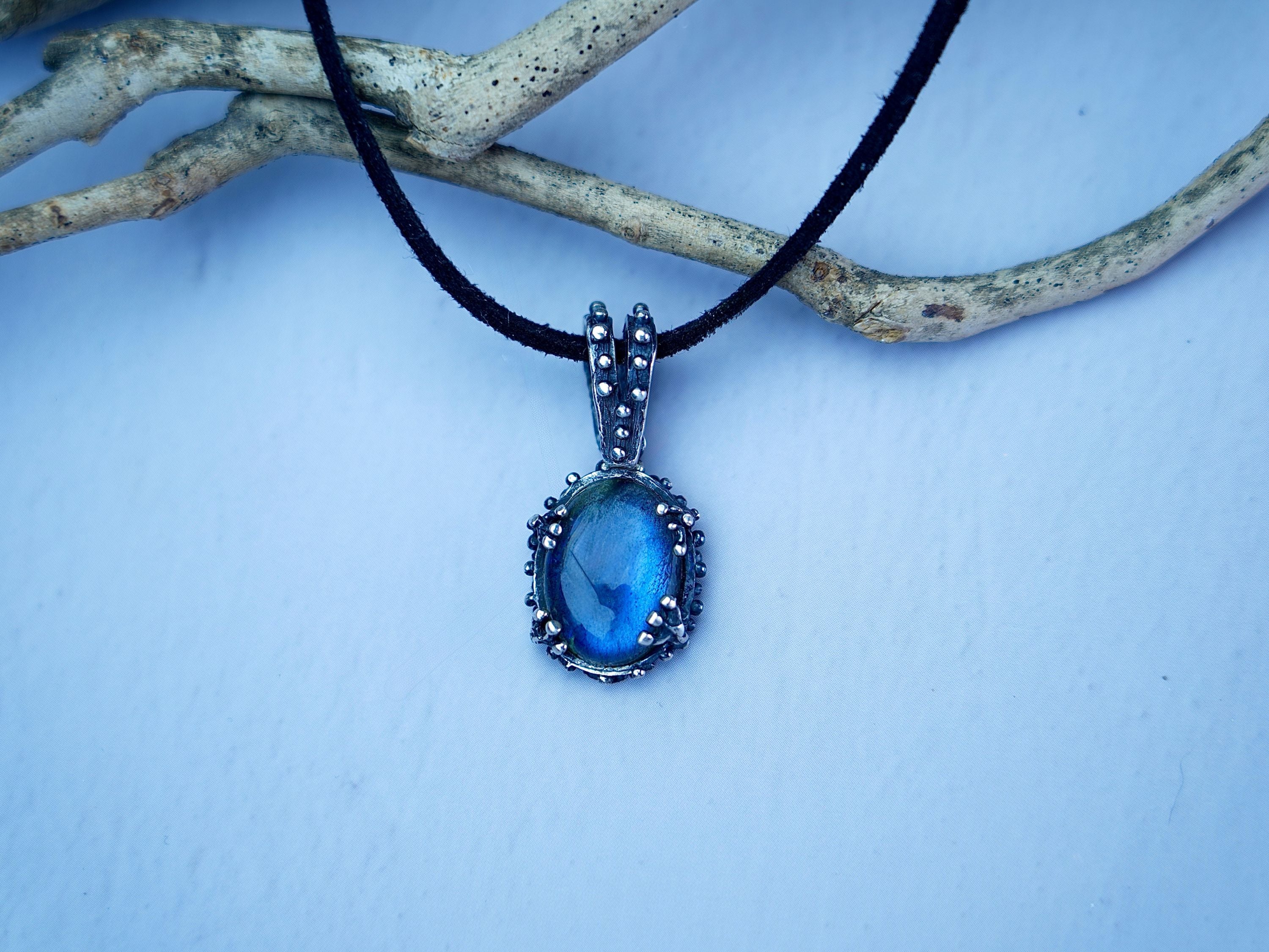Lifestyle labradorite necklace blue flash jewelry natural styled composition
