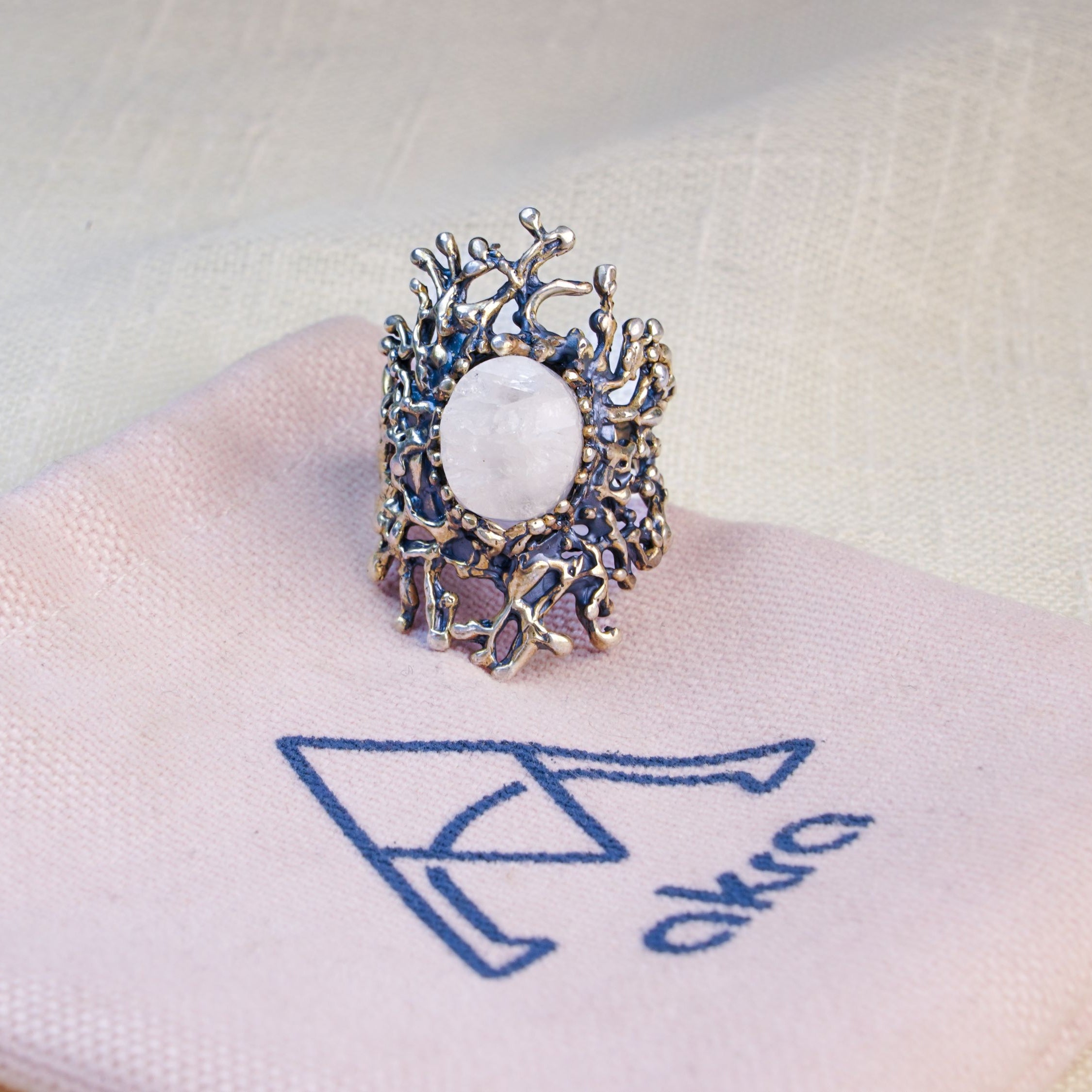 Moonstone ring on pouch jewelry branding presentation aesthetic