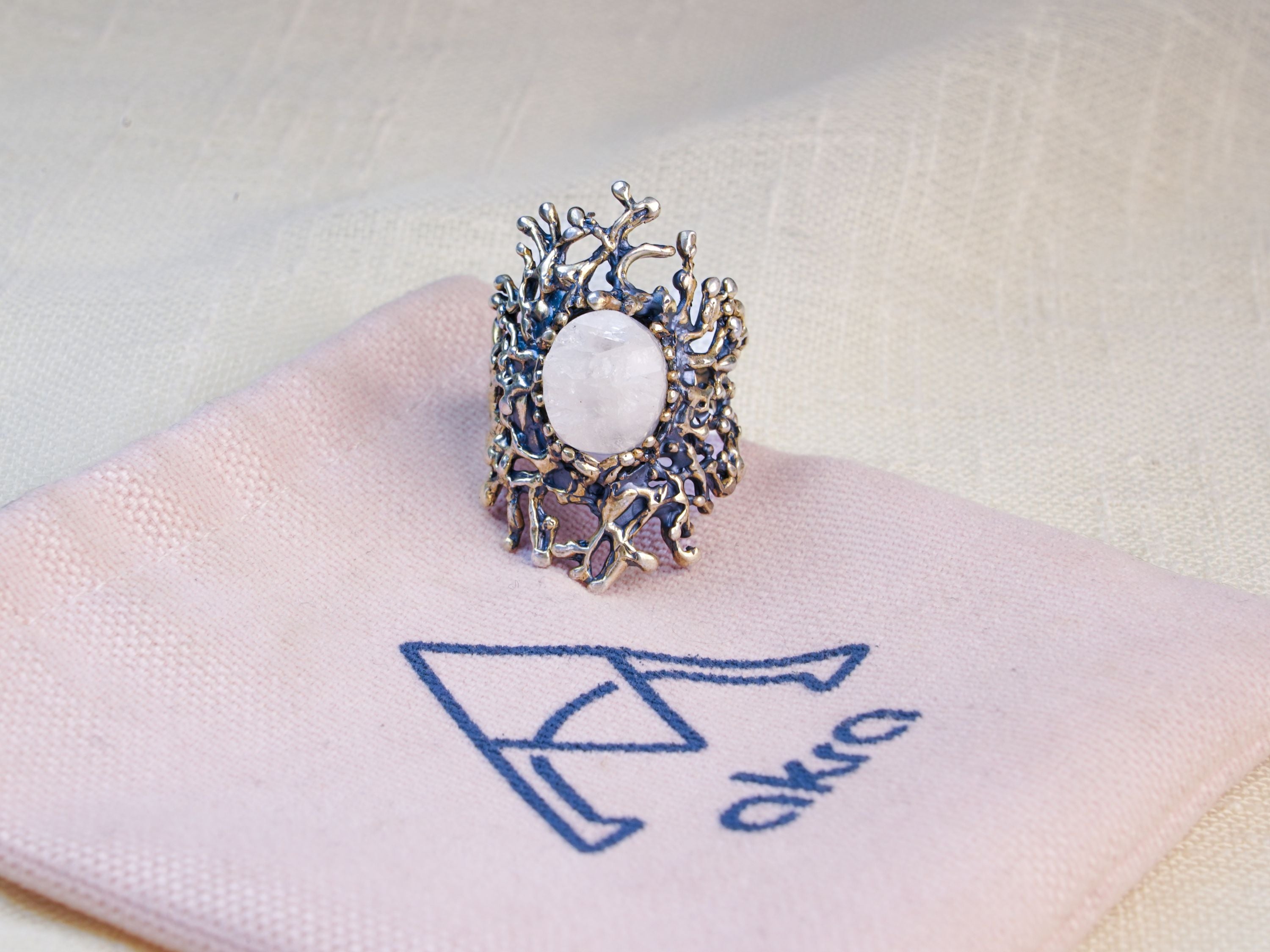 Moonstone ring on pouch jewelry branding presentation aesthetic