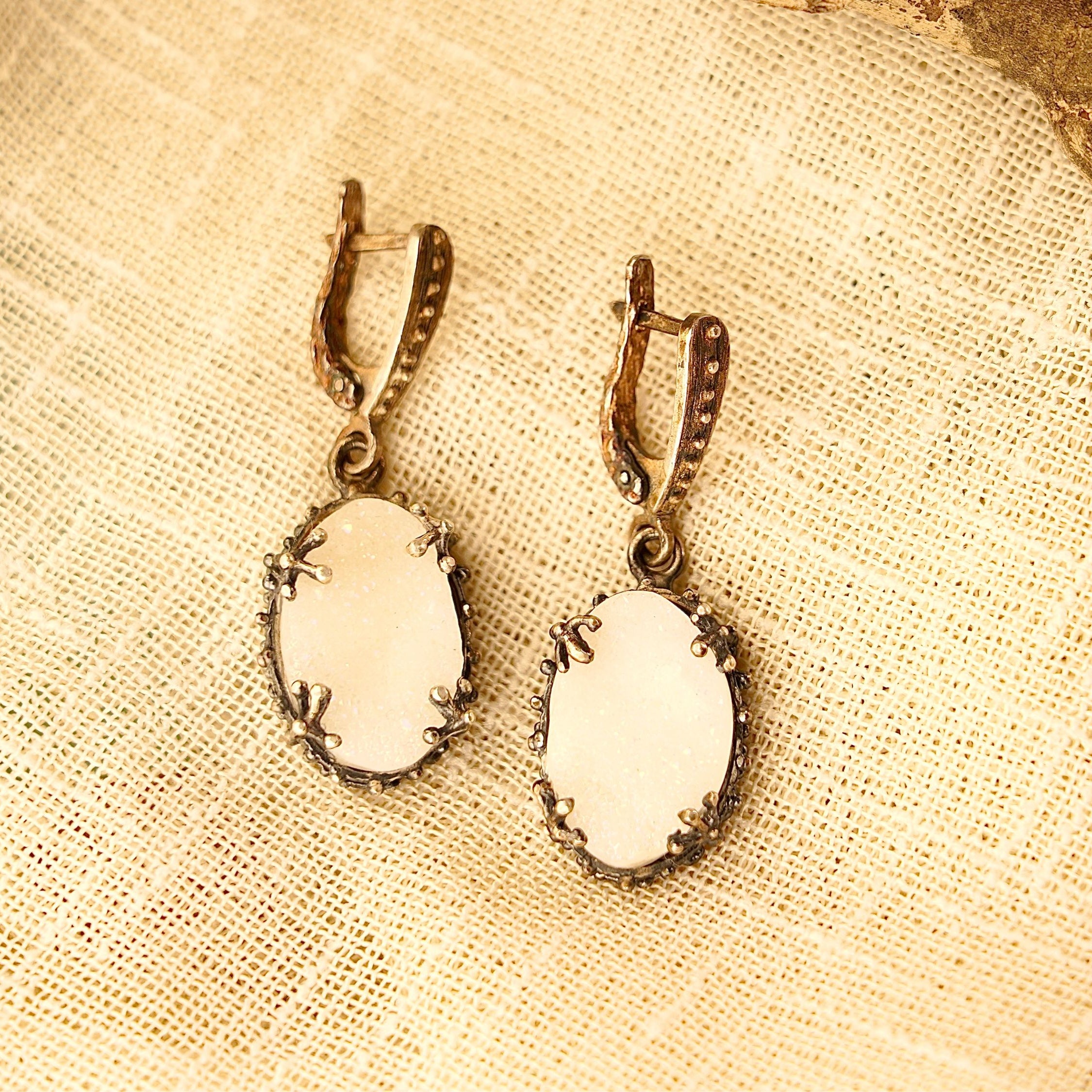 Lifestyle moonstone drop earrings elegant white gemstone jewelry styled composition