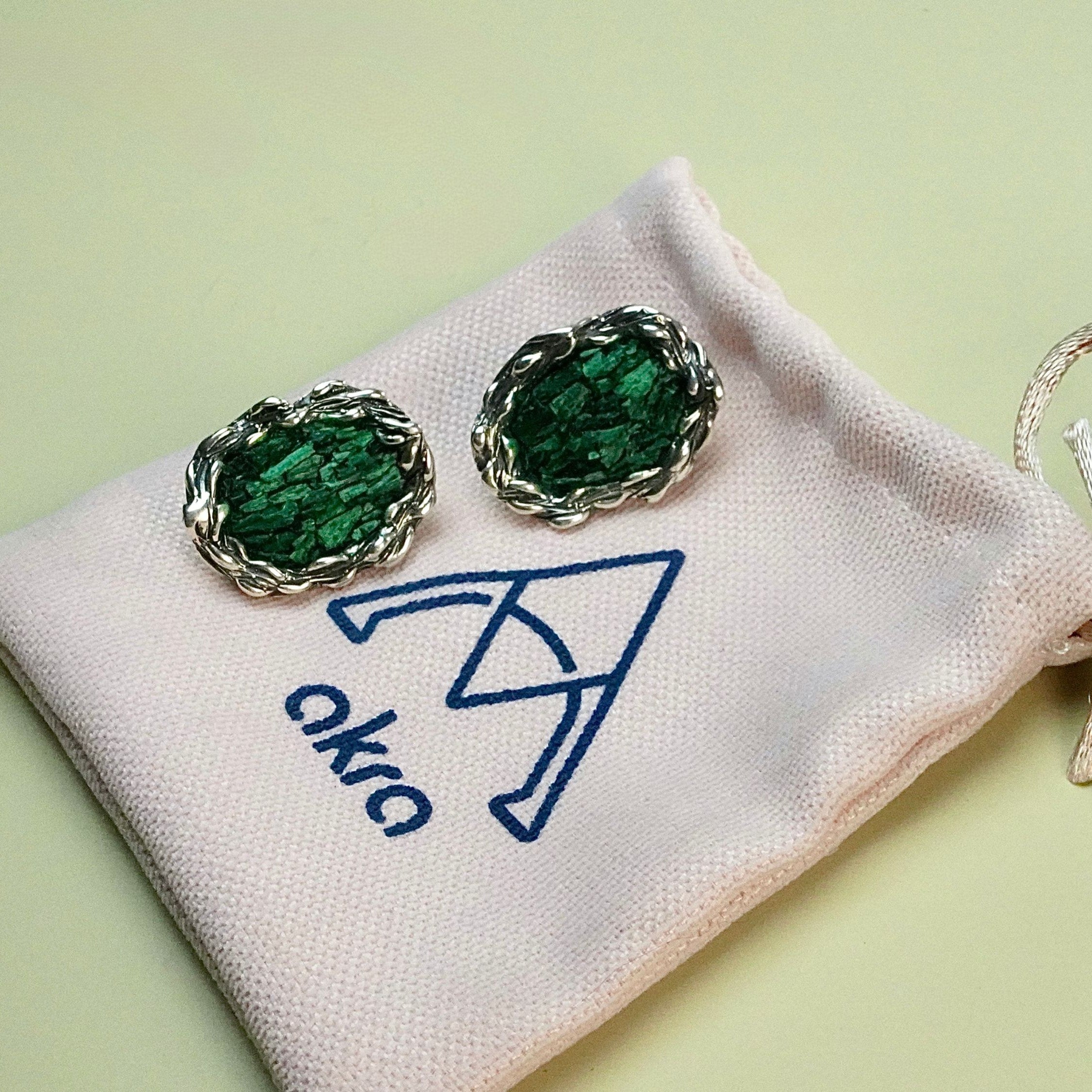 Lifestyle malachite earrings on hand natural green stone jewelry styling