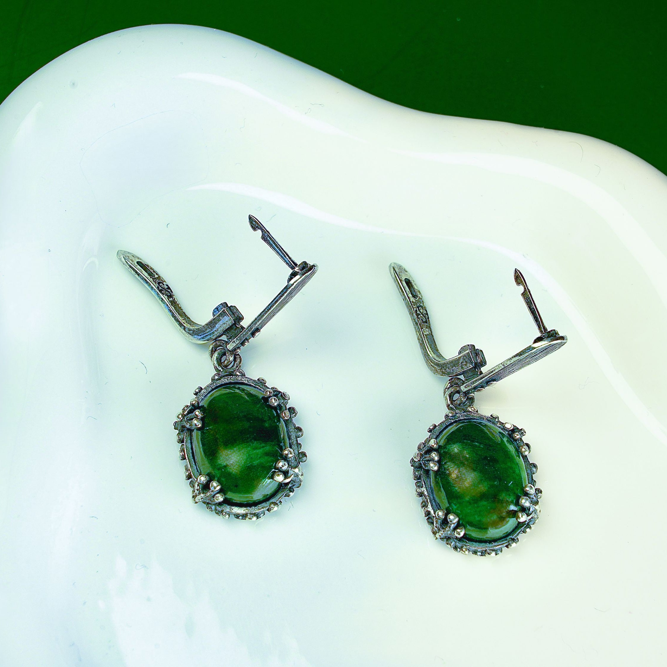Lifestyle jade earrings green gemstone jewelry aesthetic styled composition