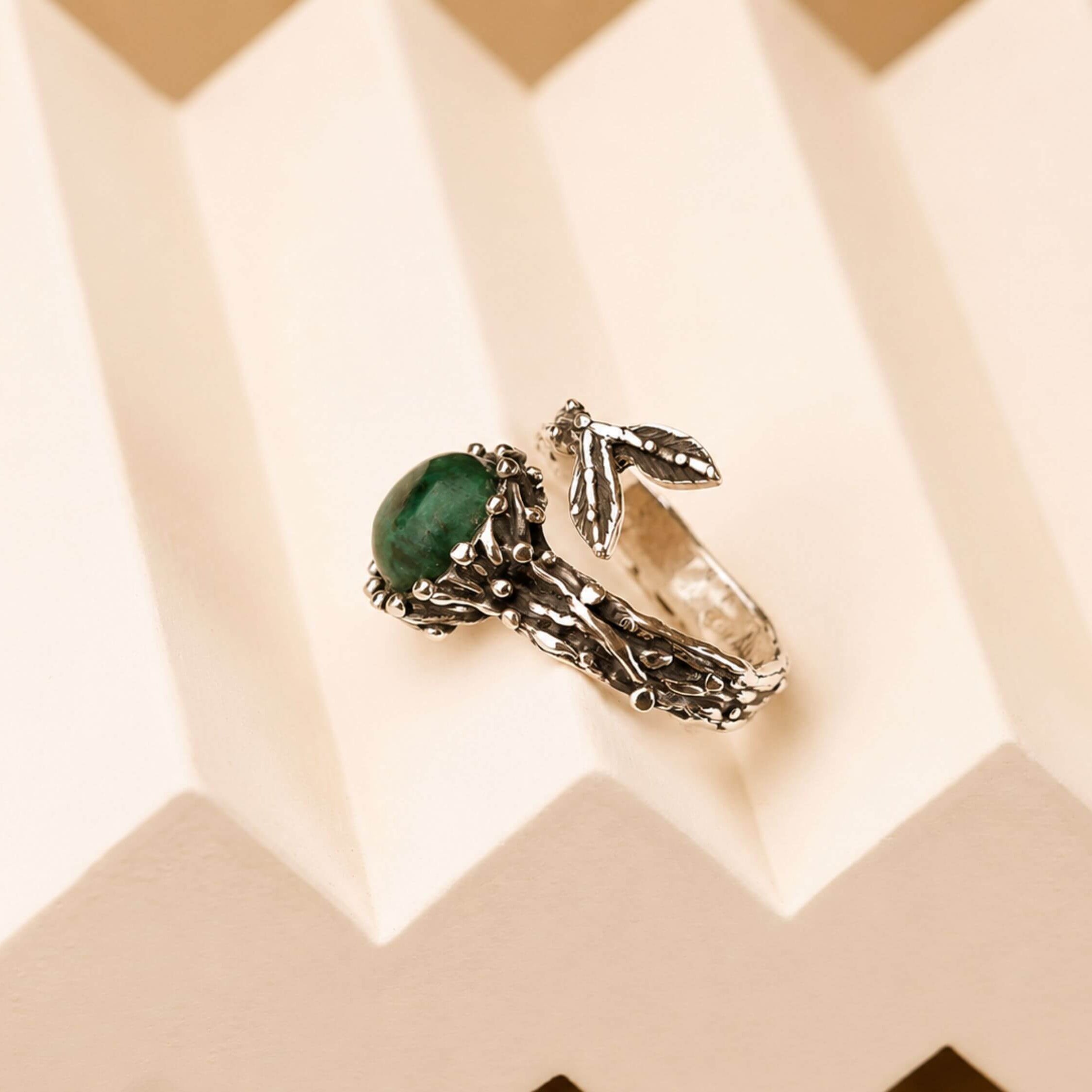 Side profile of the Jade ring, showcasing the thick artisan sterling silver band and the secure placement of the raw stone.