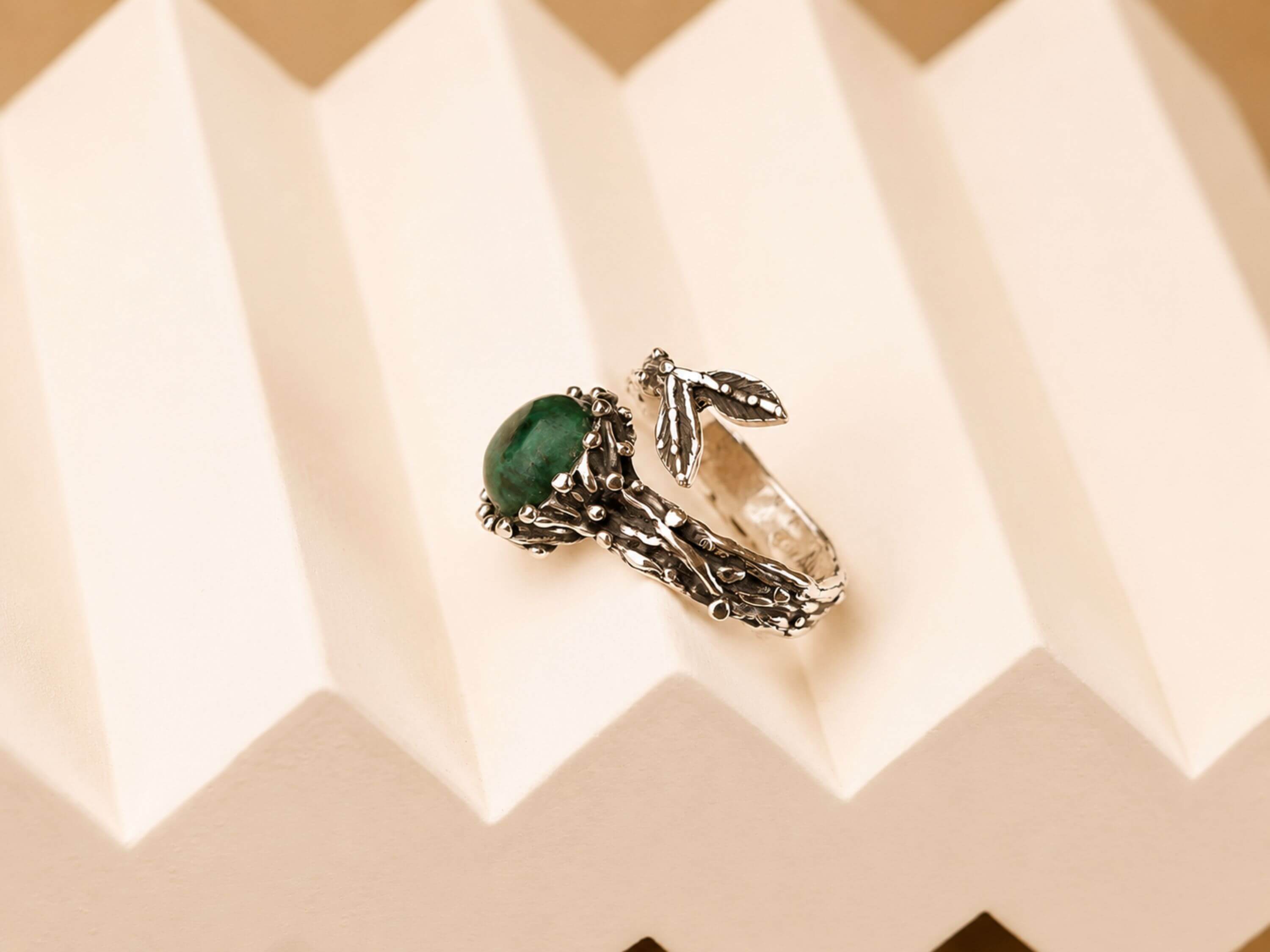Side profile of the Jade ring, showcasing the thick artisan sterling silver band and the secure placement of the raw stone.