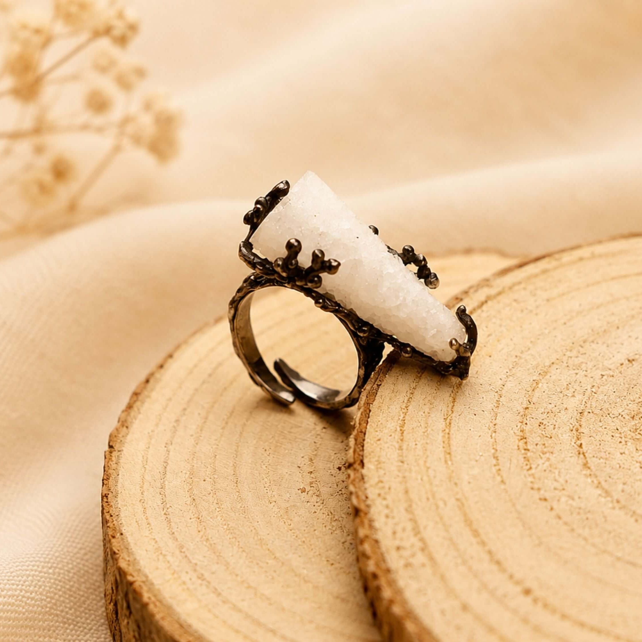 Close-up of the adjustable ring band, showing the dark textured finish and the flexible design suitable for various finger sizes.