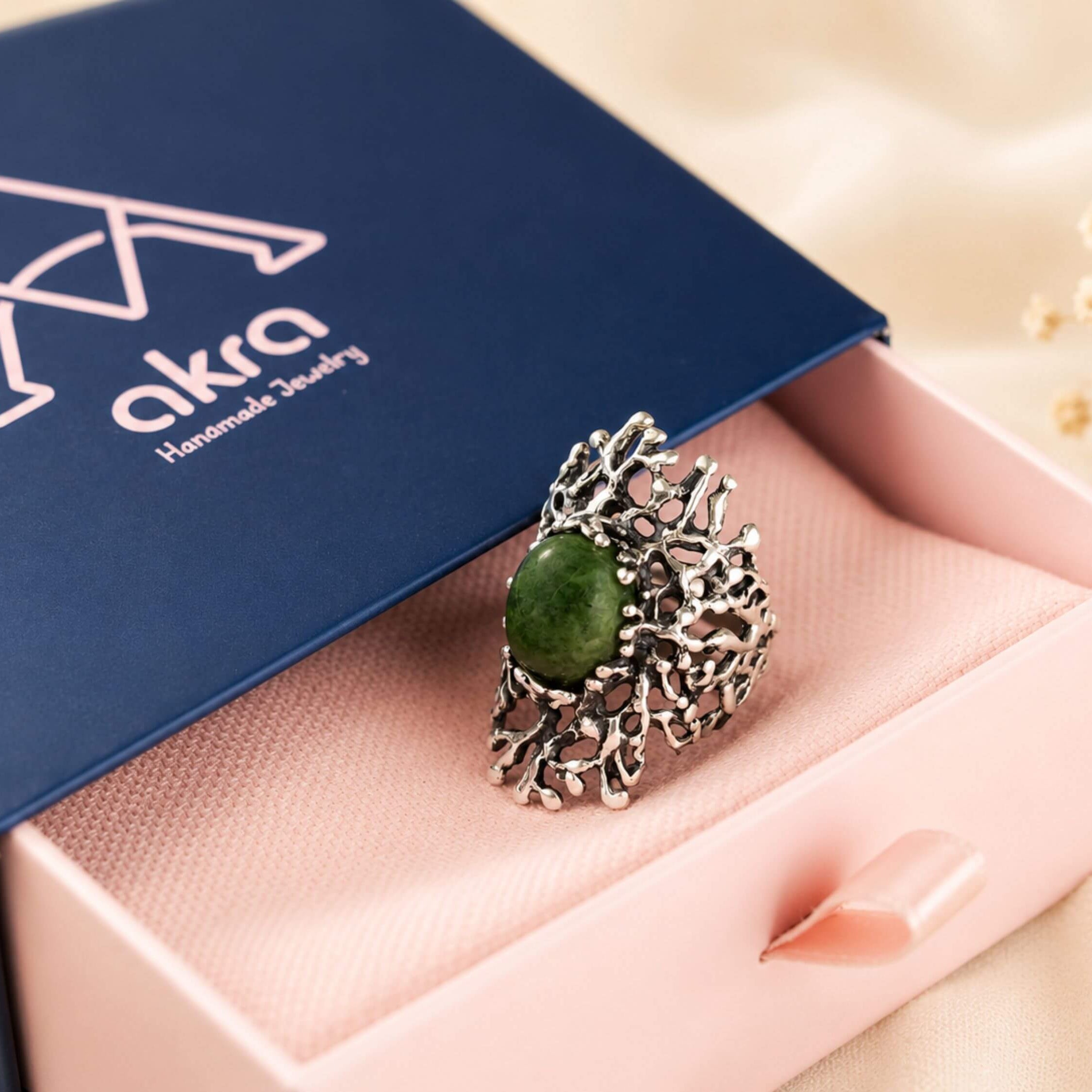 The green Jade statement ring presented in Akra Gems premium blue gift box, perfect for luxury gifting.