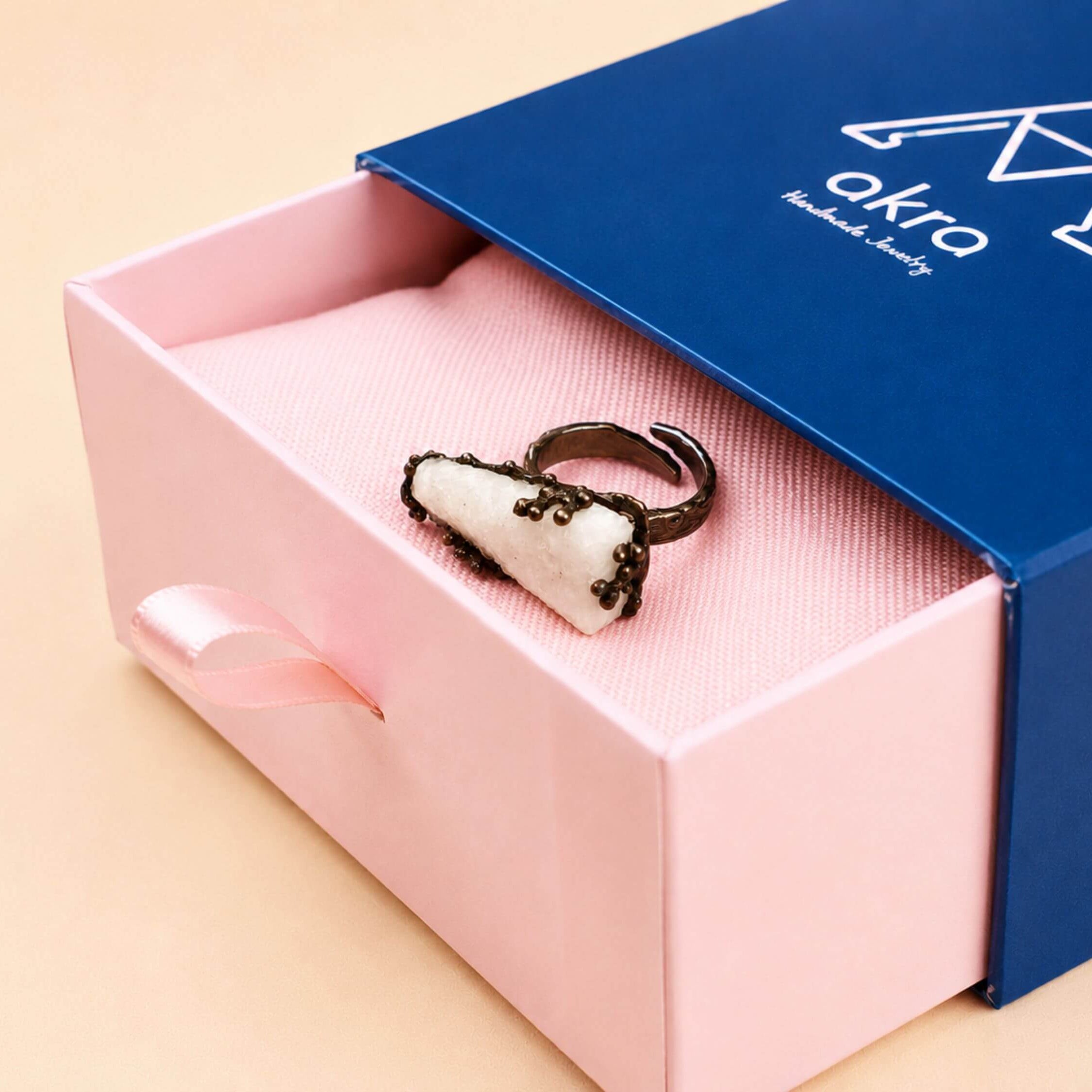 The raw Moonstone ring presented in Akra Gems' premium blue and pink signature gift box, ready for high-end gifting.