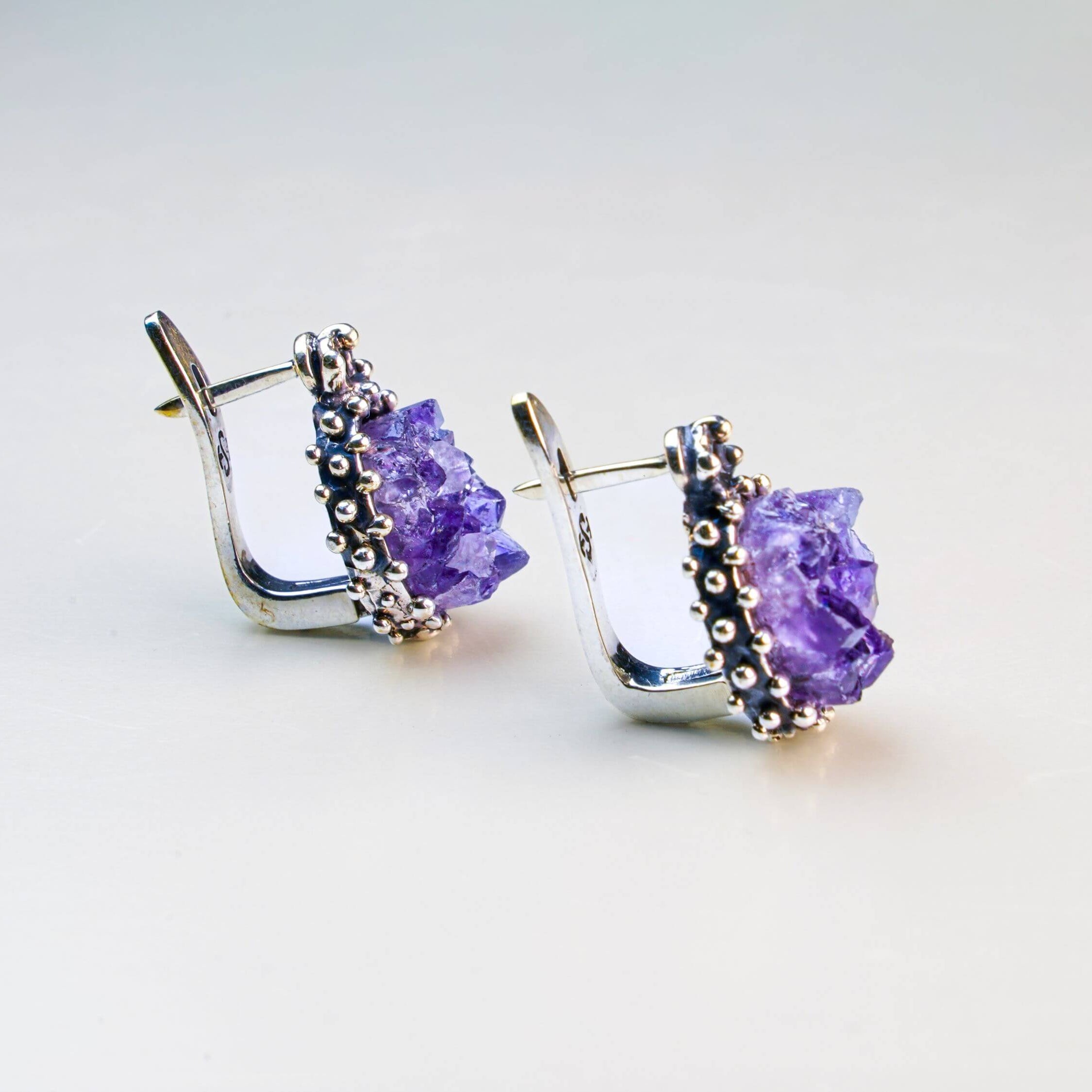 A pair of artisan amethyst earrings, showcasing unique natural stones handcrafted by Akra Gems in Tbilisi