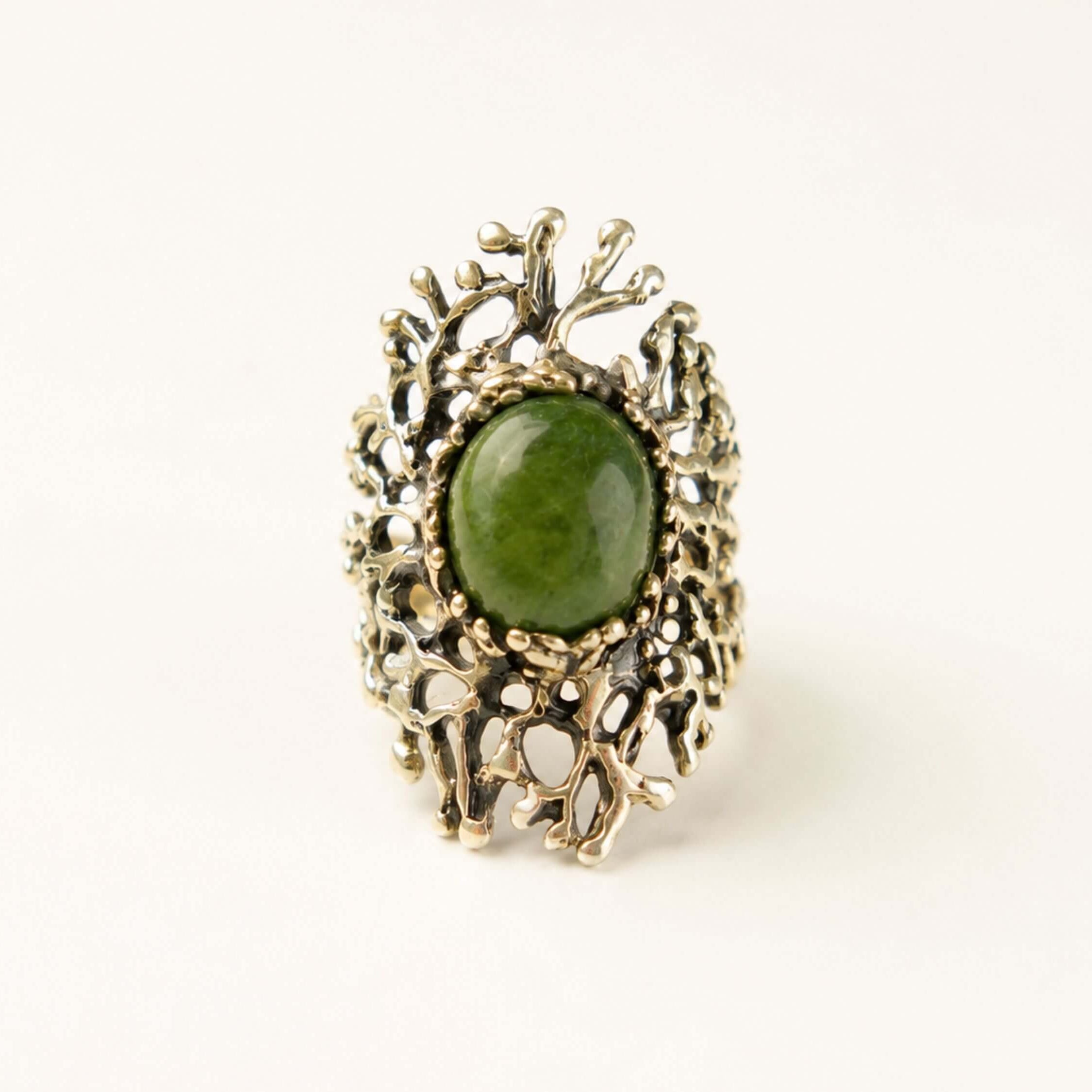 Direct front view of the green Jade ring, illustrating the symmetrical beauty of the stone and its powerful presence as a statement piece.