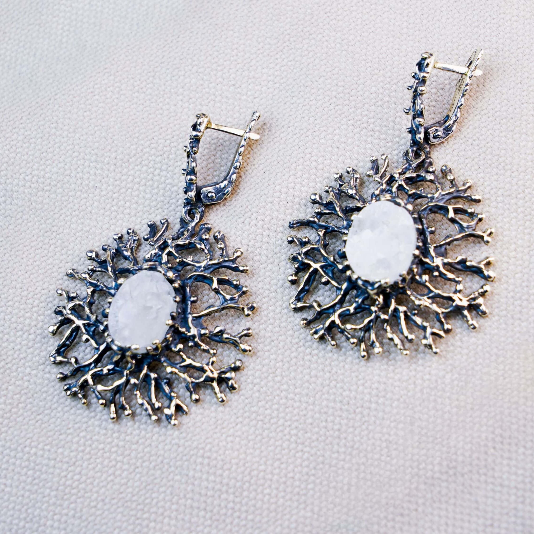 Statement Moonstone drop earrings featuring an intricate sterling silver branch design, showcased on a neutral background