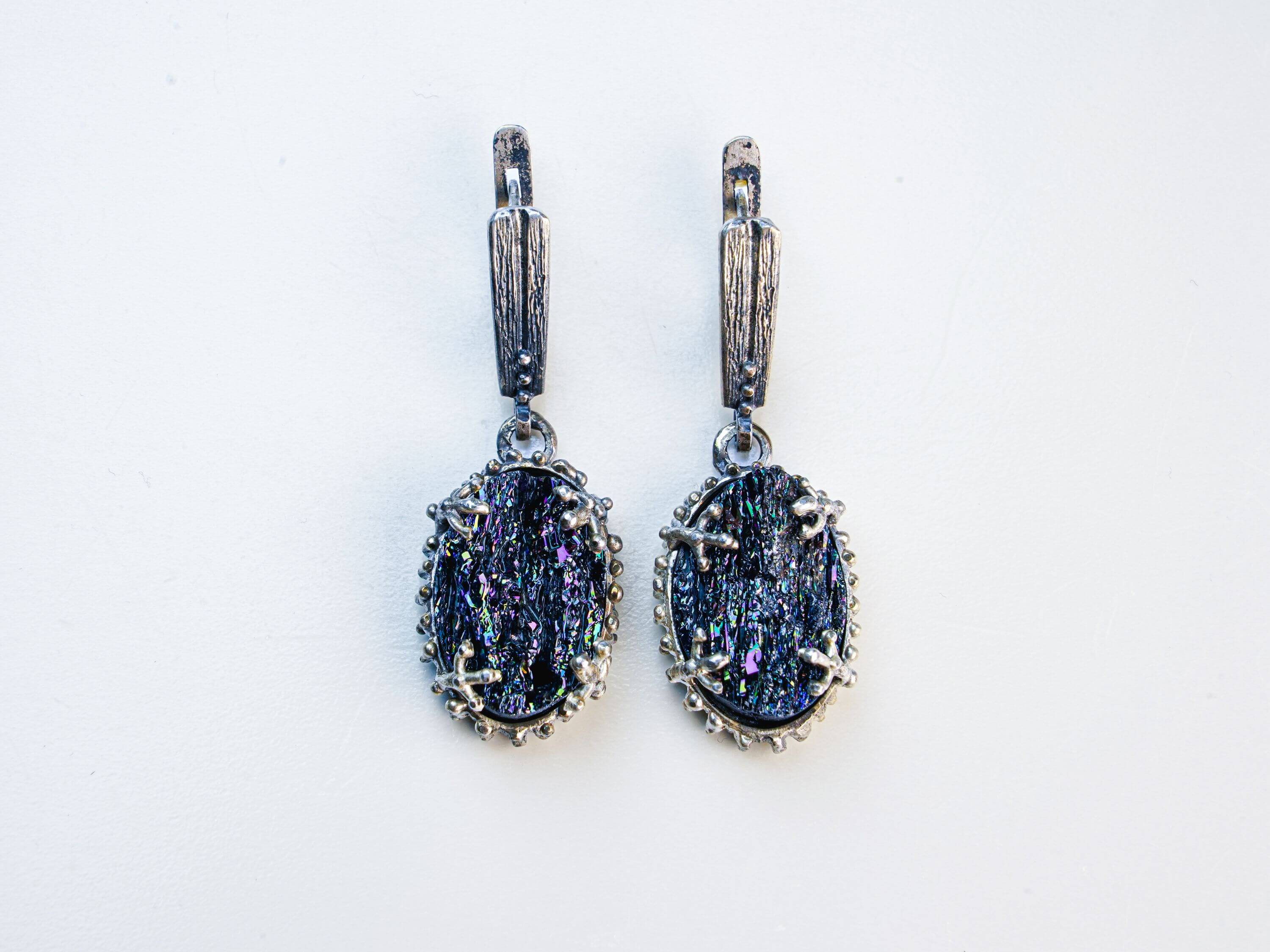 Front-facing symmetrical shot of the tourmaline earrings, emphasizing the contrast between the dark stone and the detailed oxidized silver