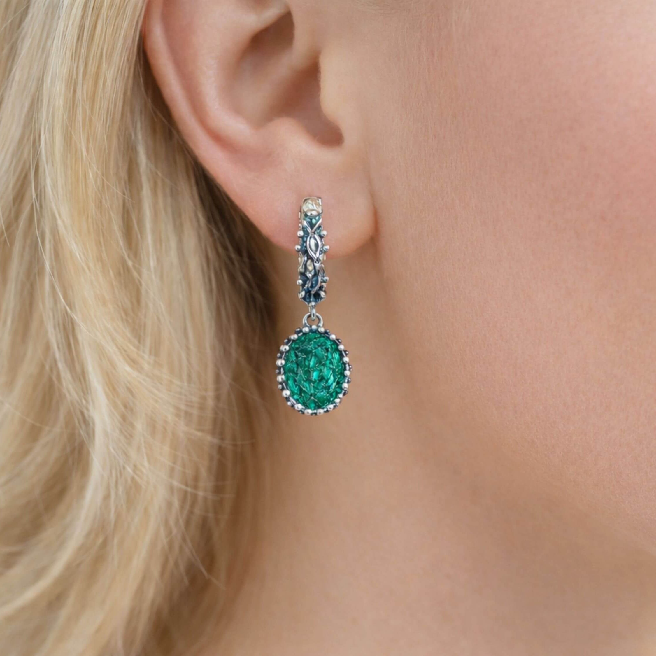 Side profile view of a woman wearing Akra Gems natural Malachite oval earrings, illustrating the size and elegant hang of the gemstone jewelry