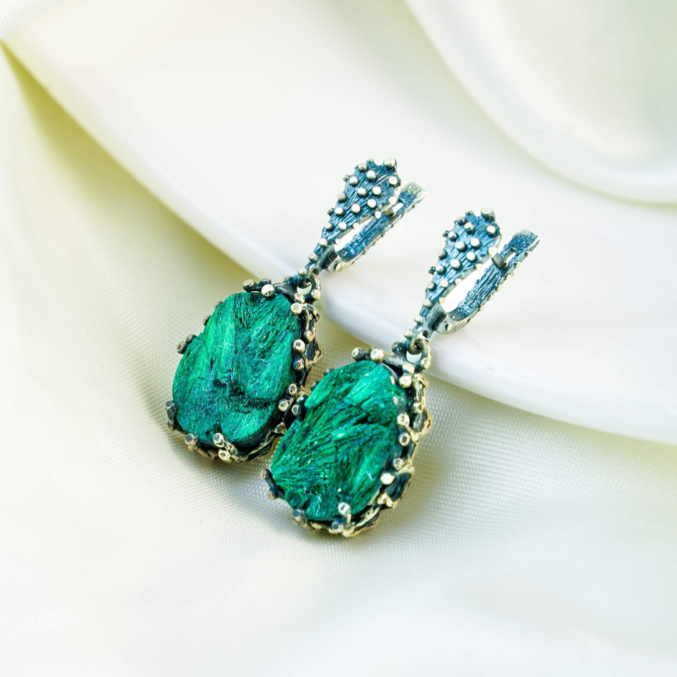 Teardrop Malachite earrings in a detailed sterling silver setting with unique green stone patterns, displayed on a clean background
