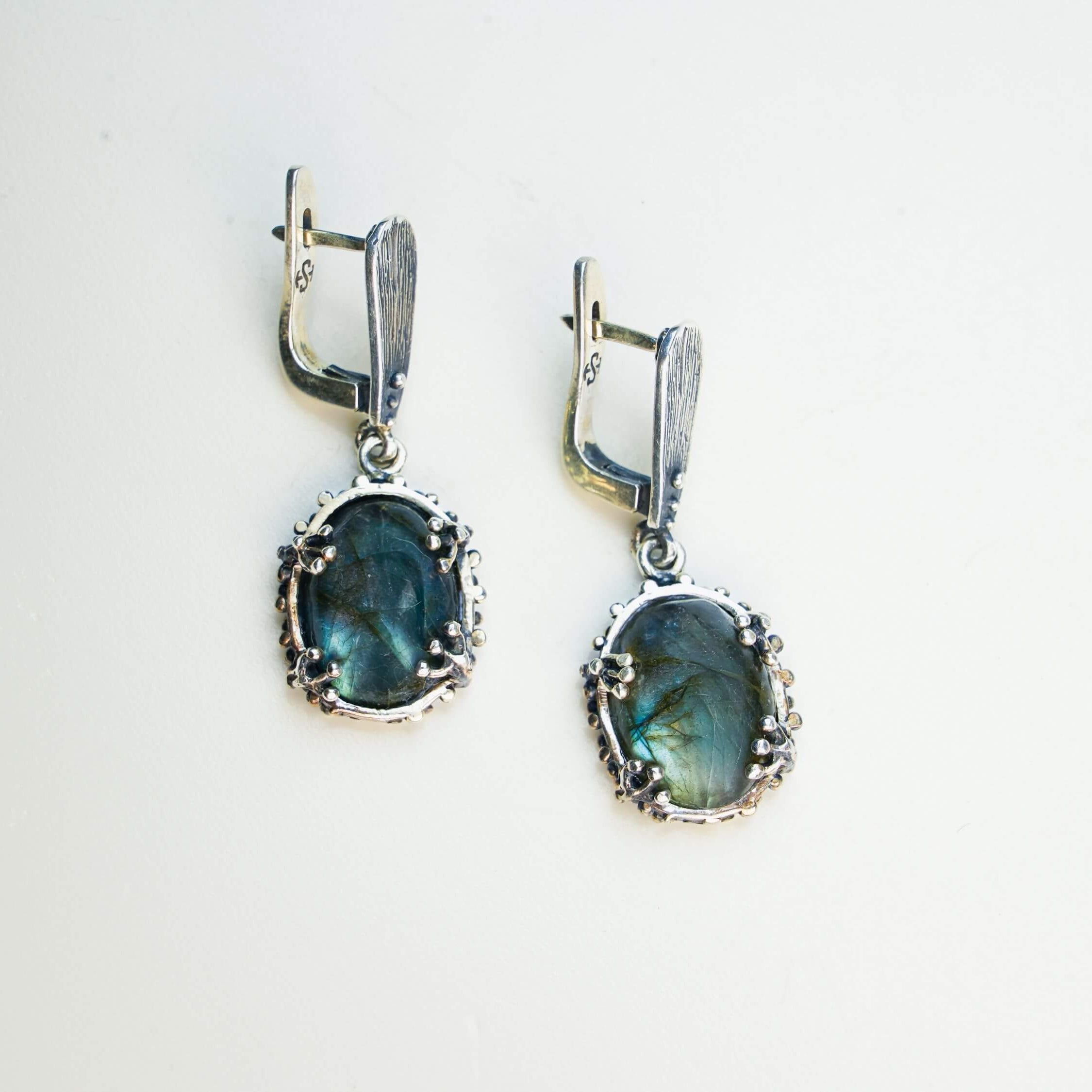 Natural labradorite earrings styled with a vintage aesthetic, emphasizing the mystical blue glow