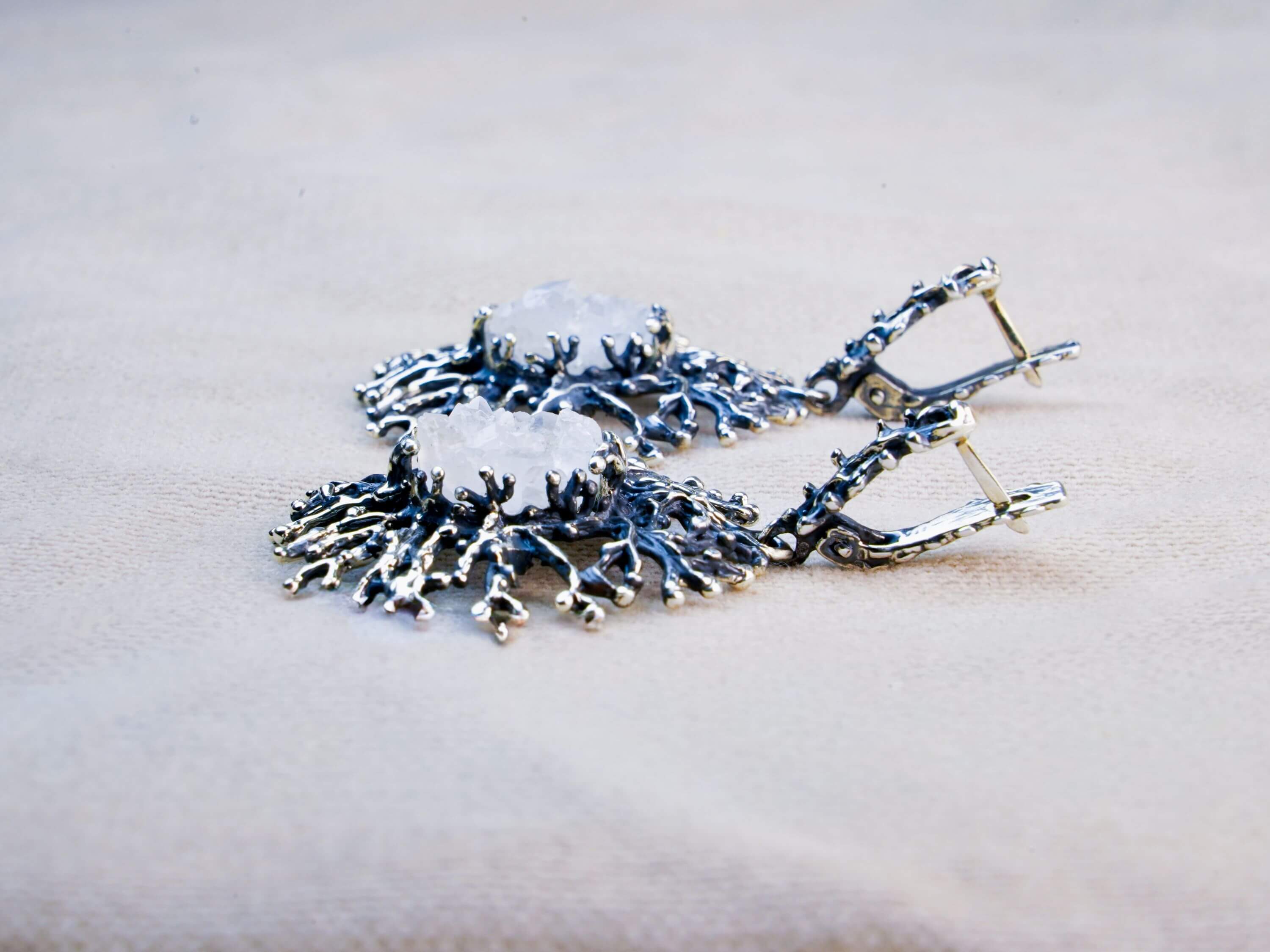 Detailed view of the Moonstone's inner glow and the artistic oxidized silver finish under natural daylight