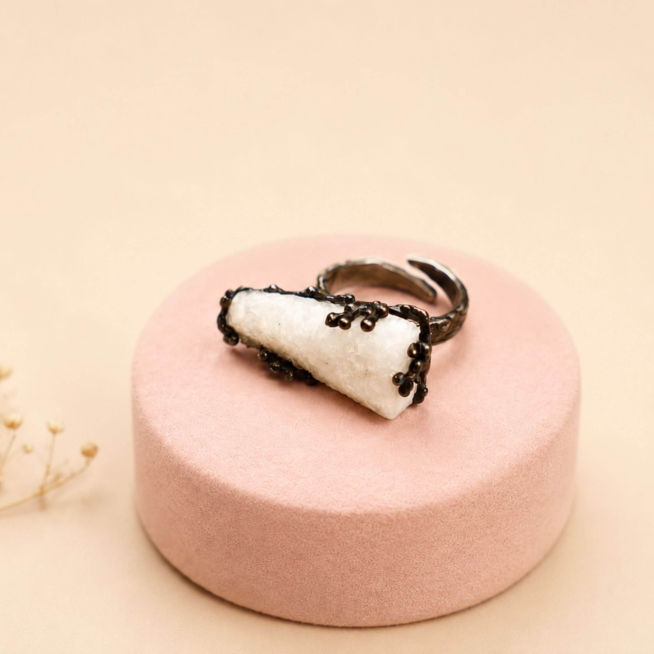 Side view of the Moonstone ring, emphasizing the unique organic texture of the oxidized sterling silver setting and the stone's elevation.