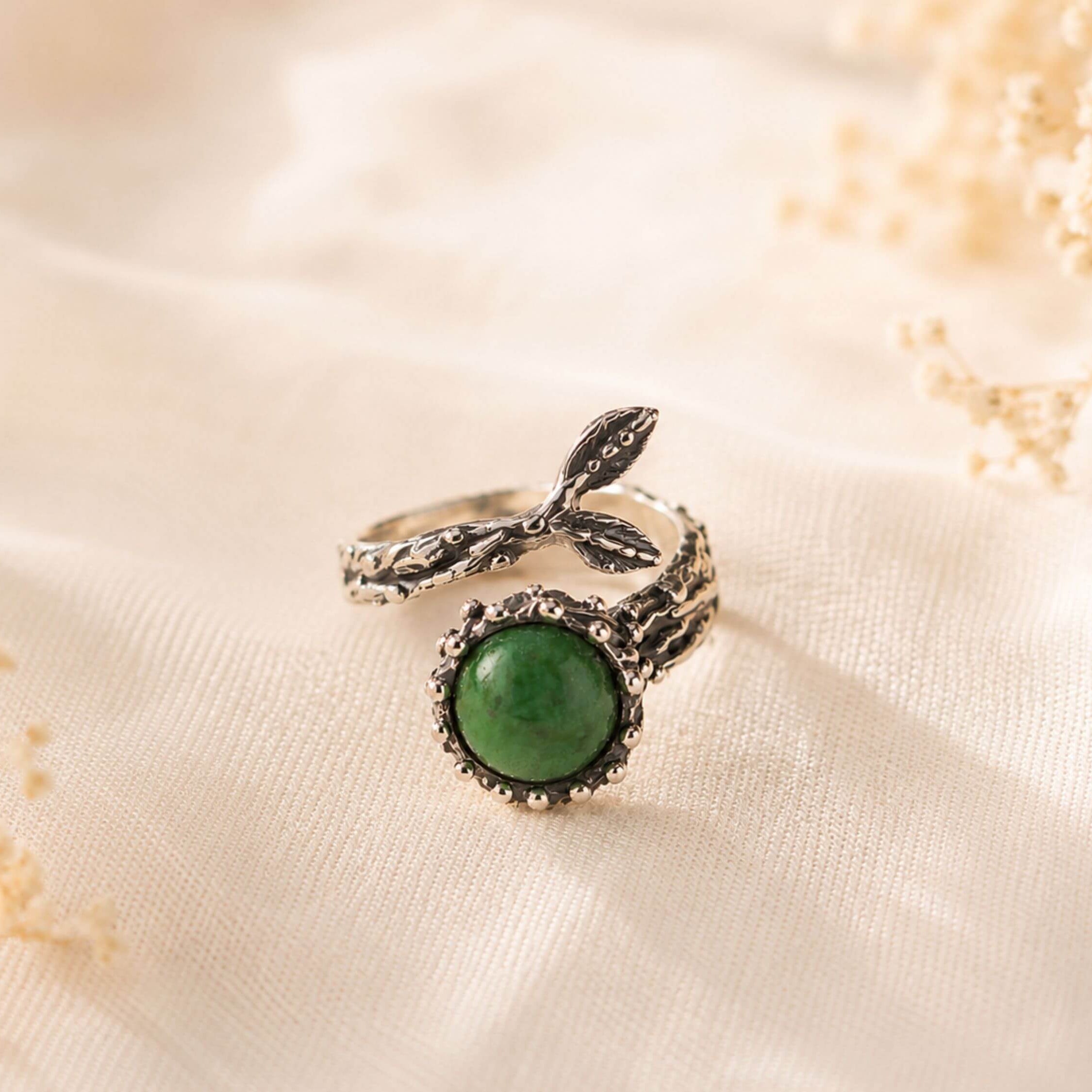 Handcrafted raw green Jade statement ring in a textured sterling silver setting, displayed on a neutral background.