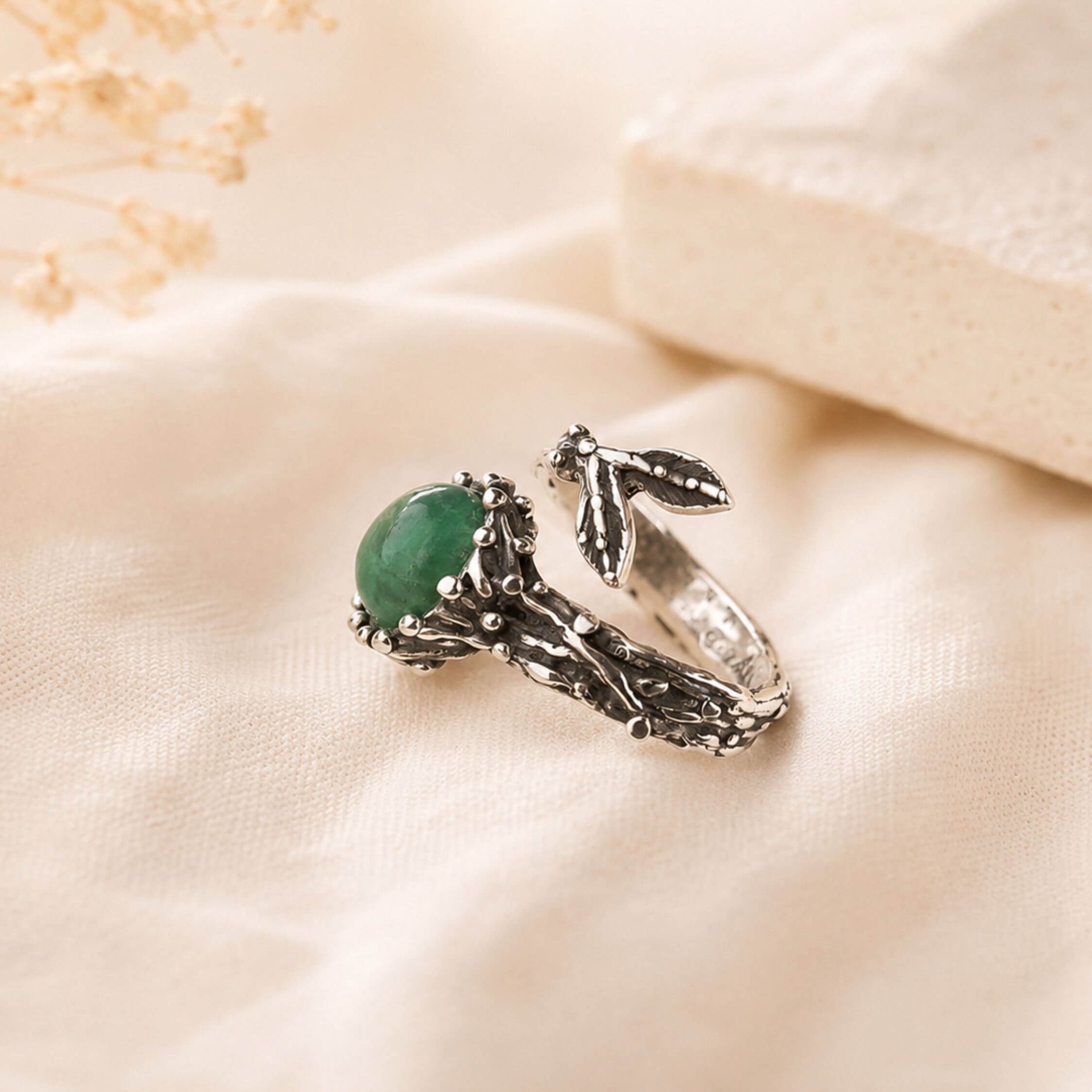 Extreme close-up of the natural Jade gemstone, highlighting the raw unpolished surface and rich green color variations.