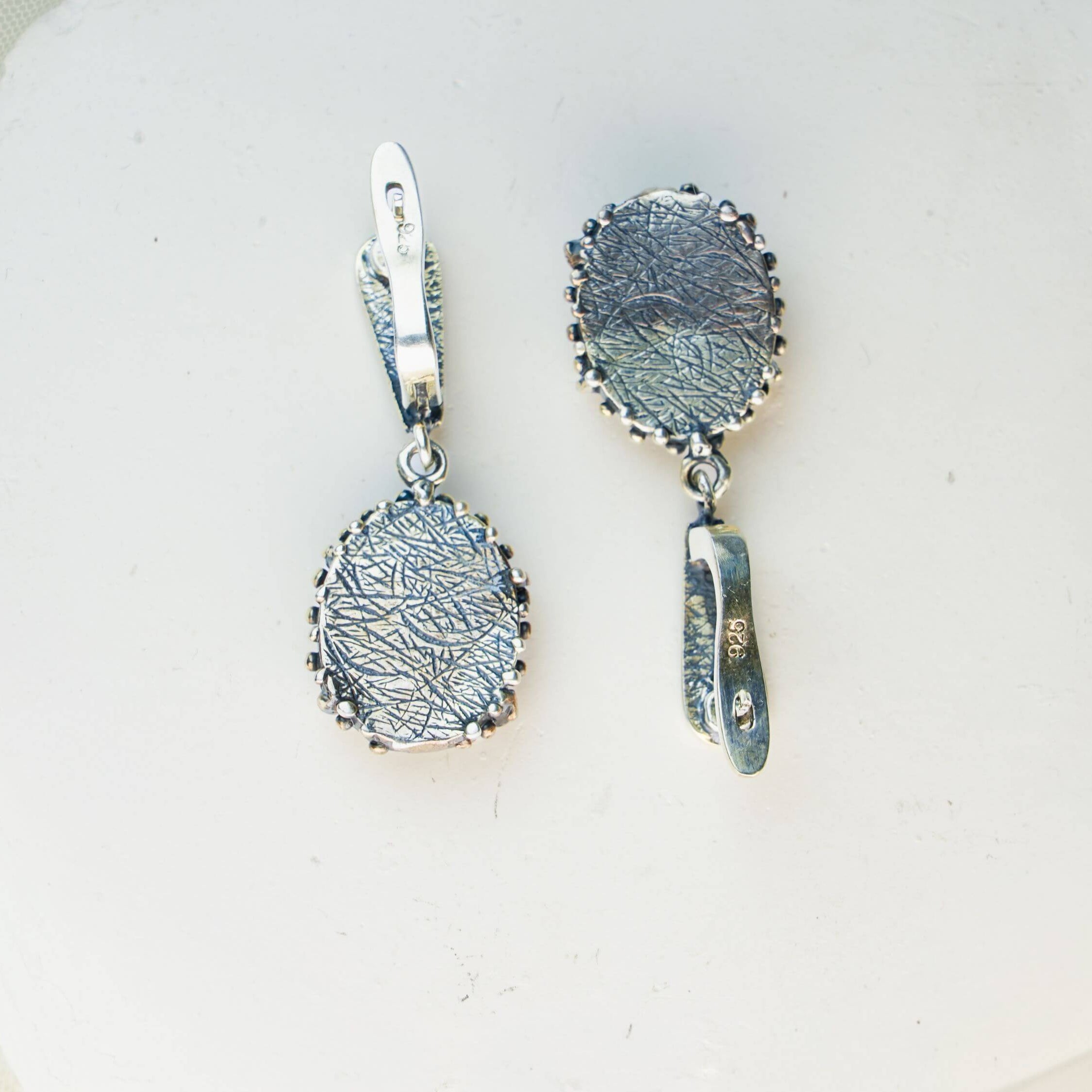 Detailed view of the secure sterling silver earring closure and polished back finish of Akra jewelry