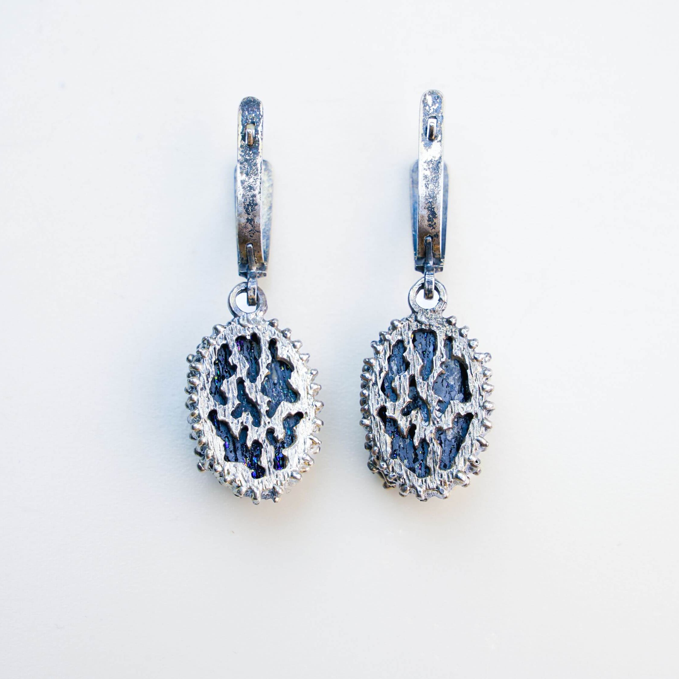 Detailed view of the back of the earring, highlighting the secure sterling silver leverback closure and artisan craftsmanship