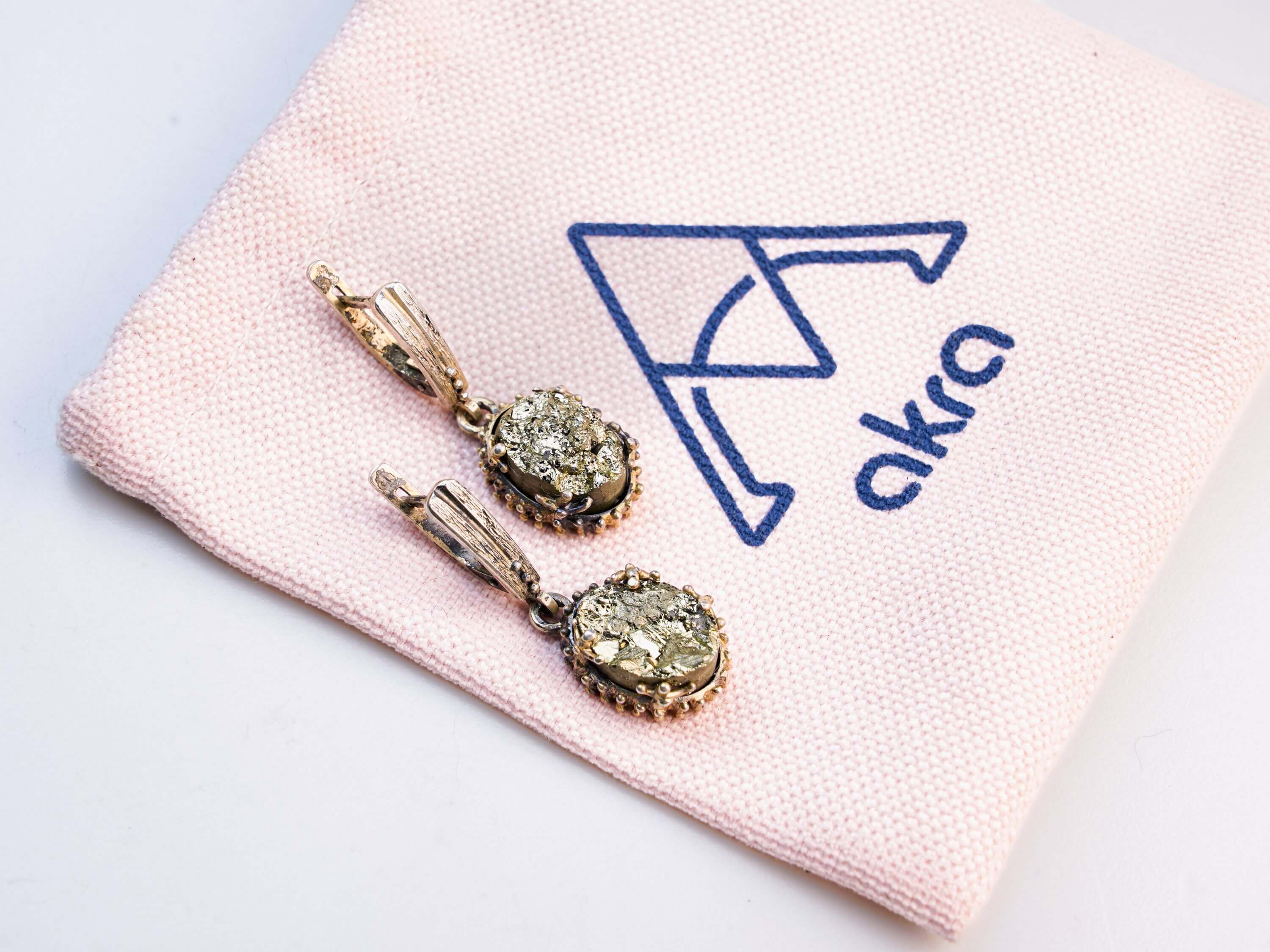 Stylized shot of pyrite jewelry, capturing its reputation as a stone of success and wealth with a sophisticated aesthetic