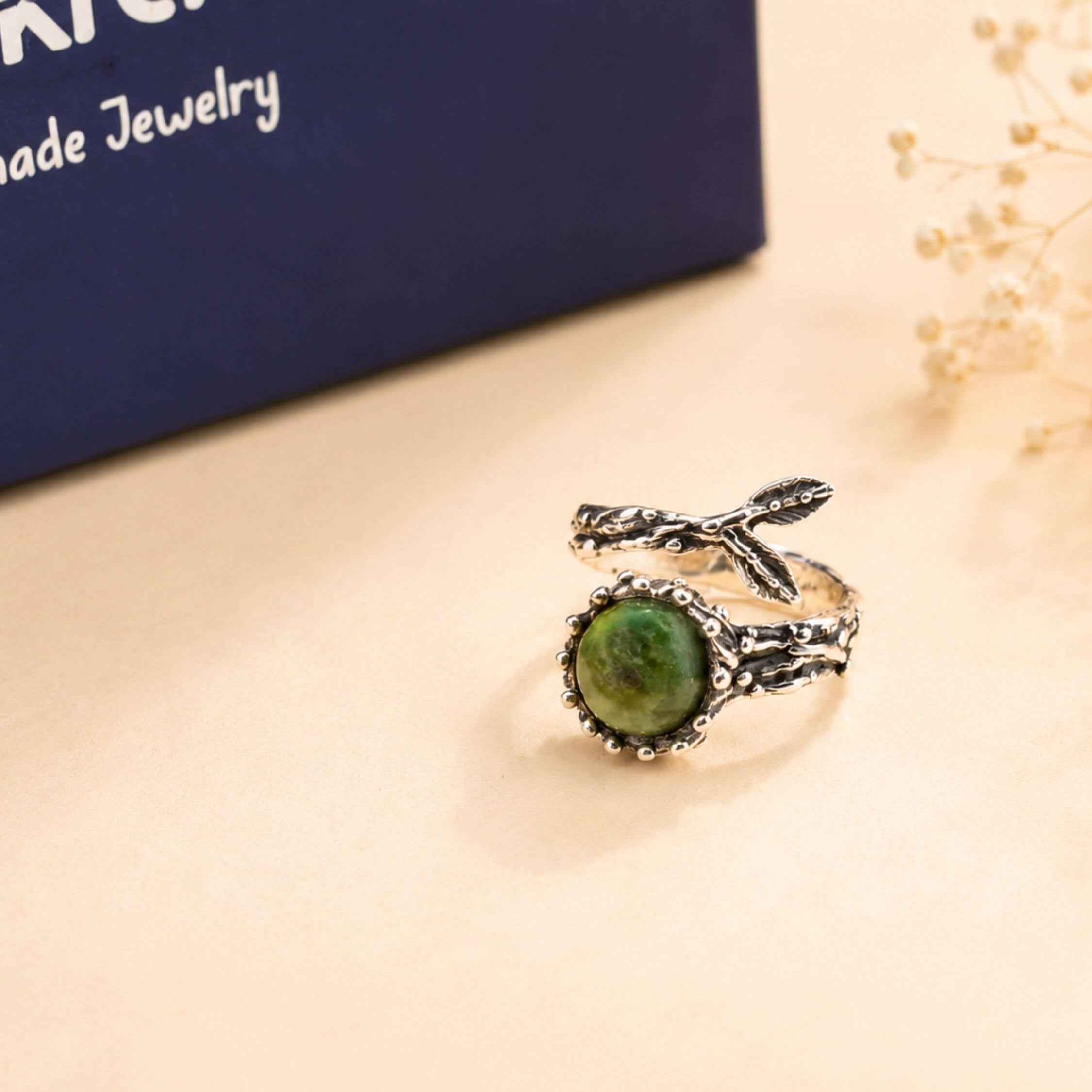 Detailed view of the unique silver 'claws' holding the raw Jade stone, highlighting the fusion of raw nature and bold jewelry design.