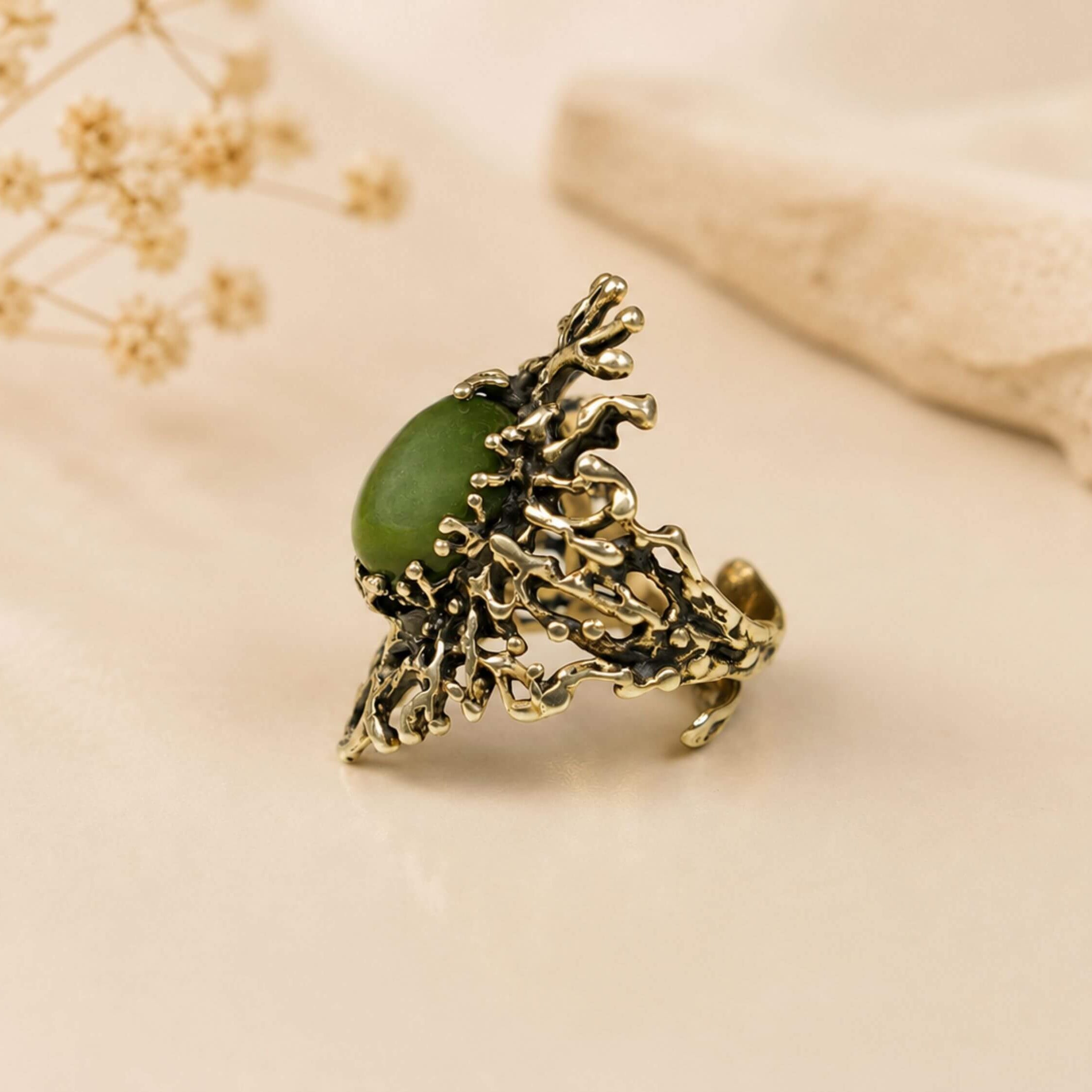 Side profile of the Jade statement ring, emphasizing the detailed artisan silver craftsmanship and the secure setting of the gemstone.