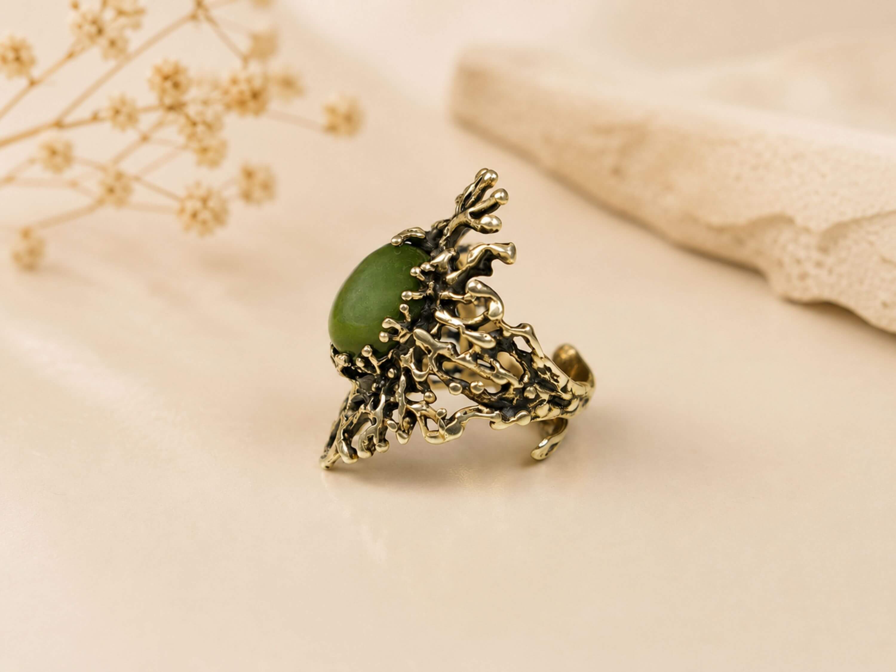 Side profile of the Jade statement ring, emphasizing the detailed artisan silver craftsmanship and the secure setting of the gemstone.