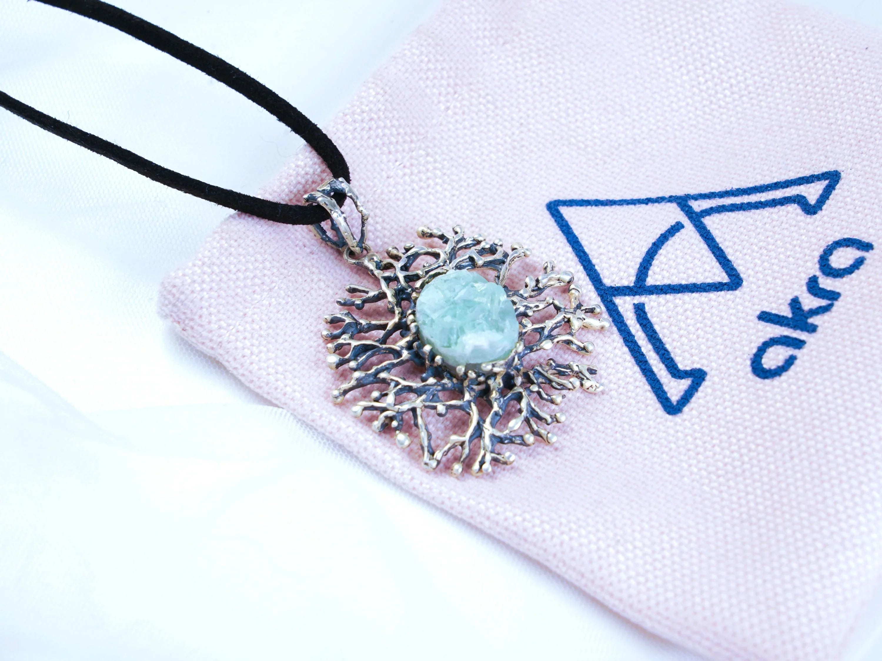 Aquamarine necklace on branded fabric aesthetic jewelry presentation