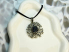 tourmaline pendant necklace on display, raw dark crystal sterling silver jewelry