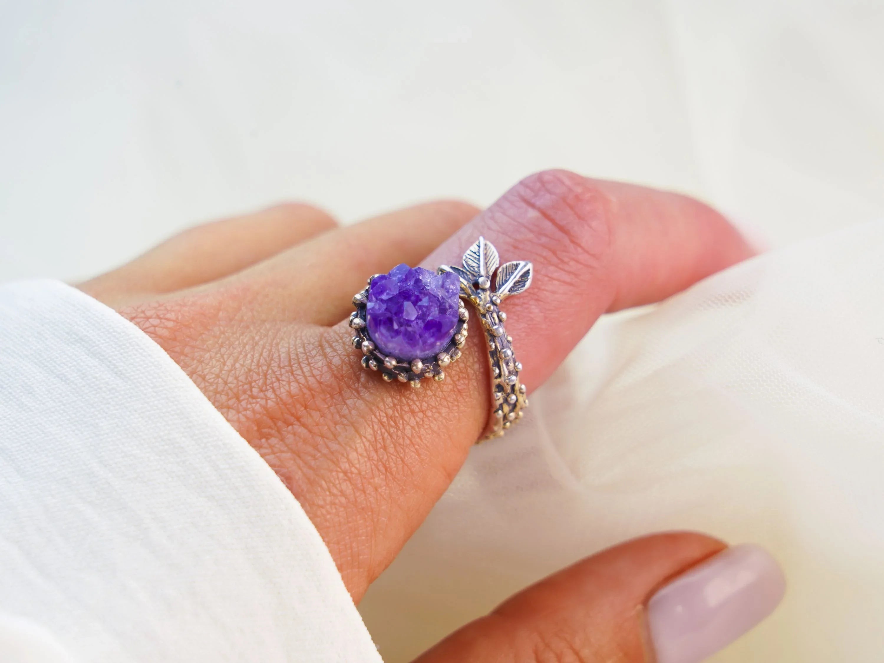 Amethyst ring worn on finger adjustable sterling silver purple gemstone jewelry